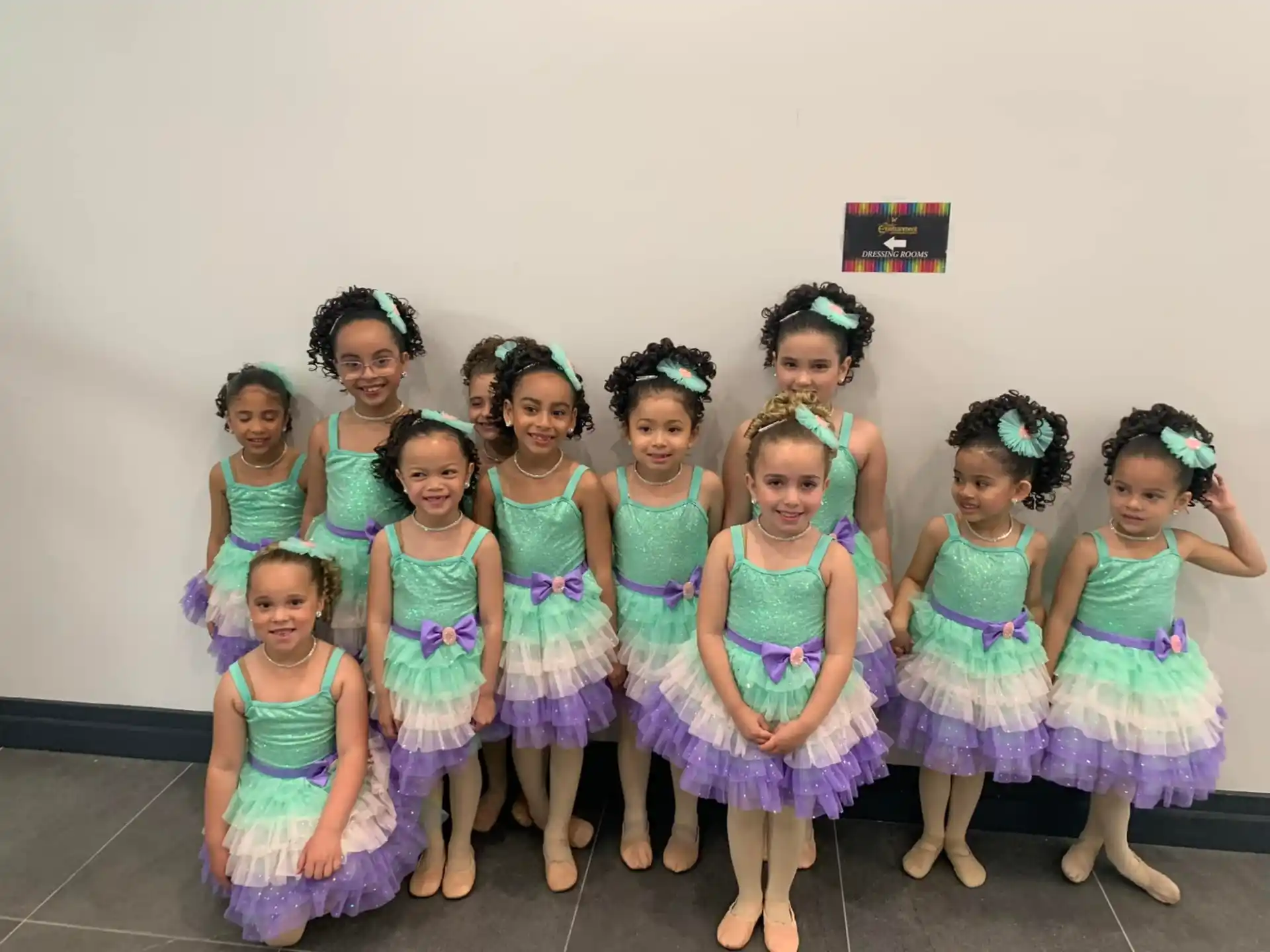 a group of girls in dresses