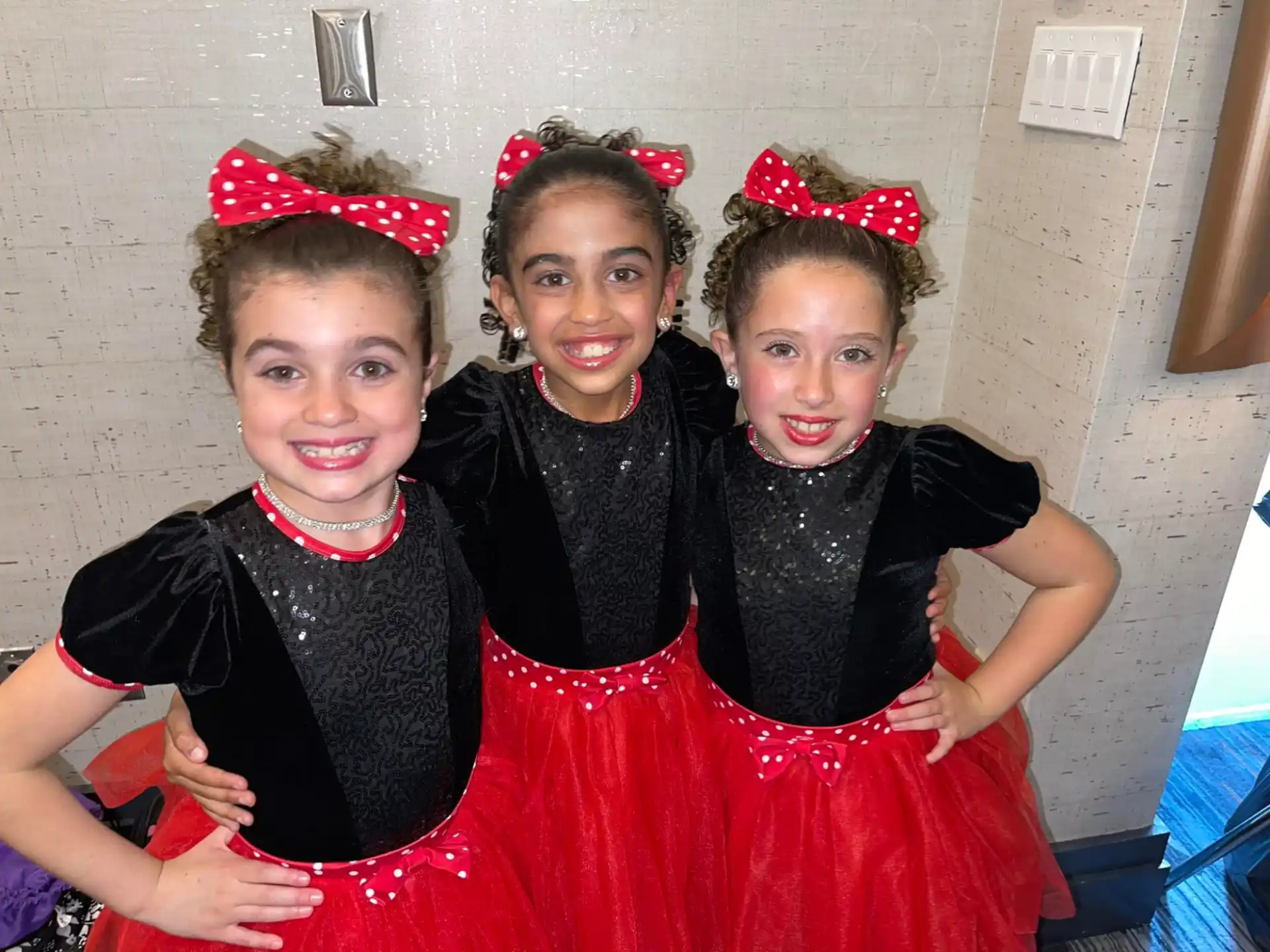 a group of girls in dresses