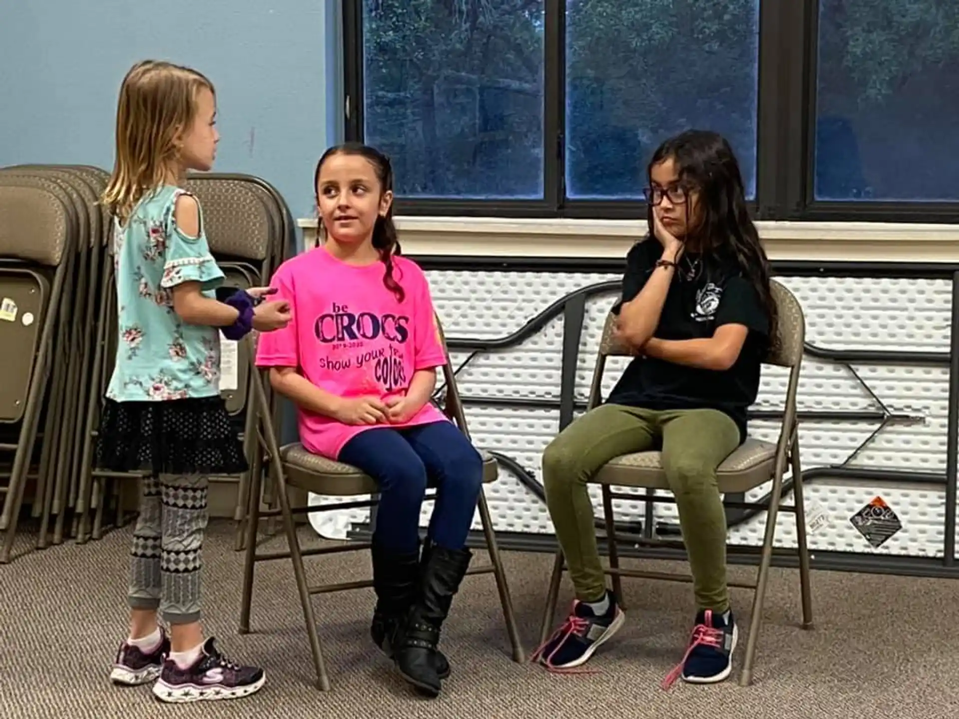 a group of girls sitting at a table