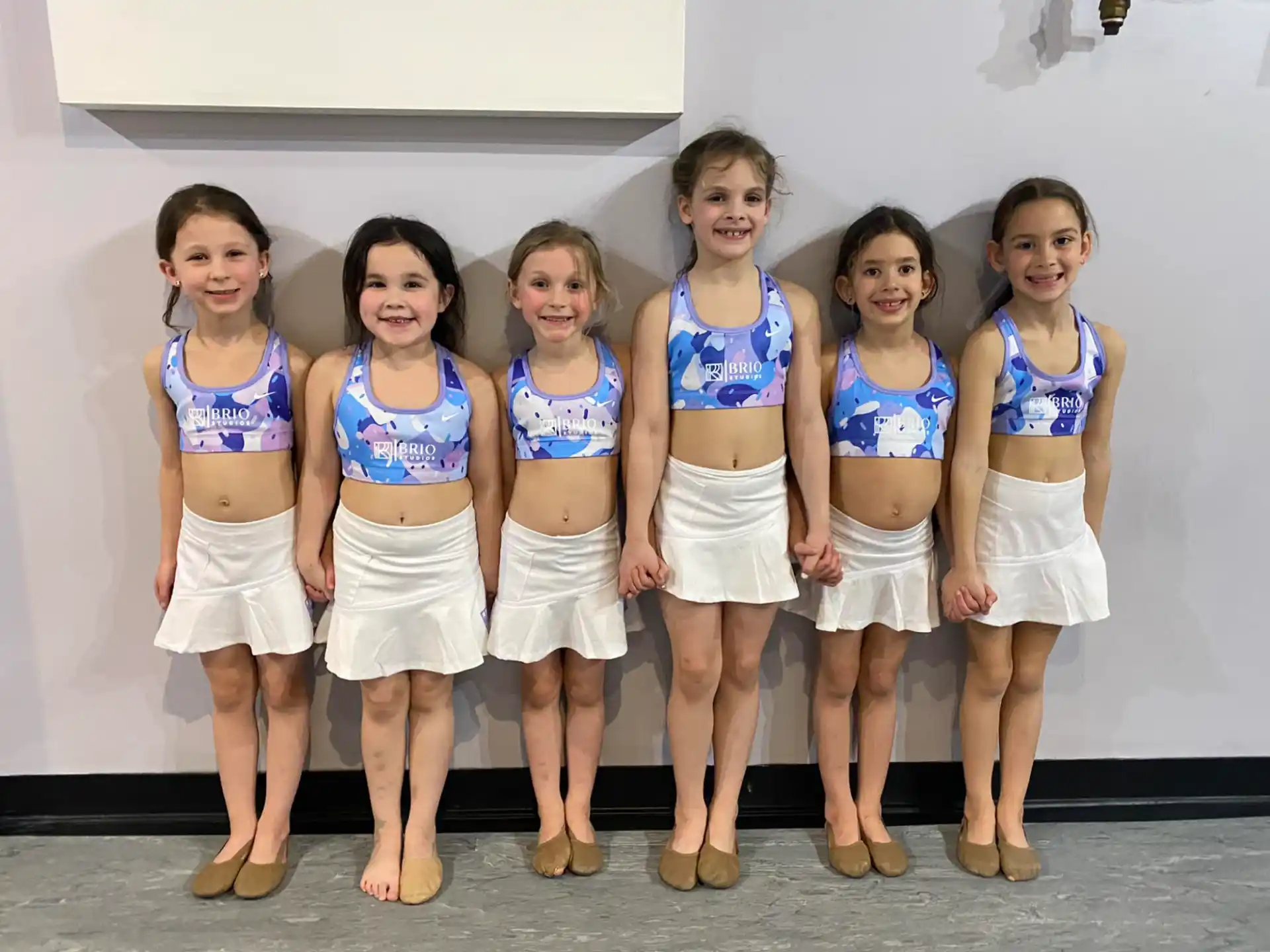 a group of women in matching outfits