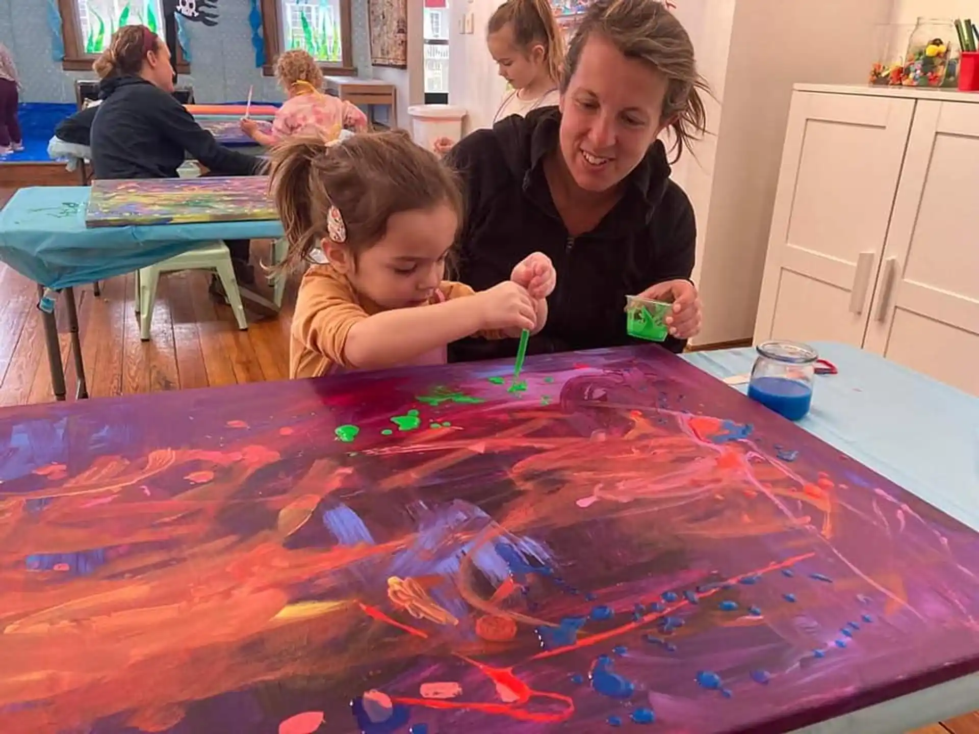 a person and a child painting