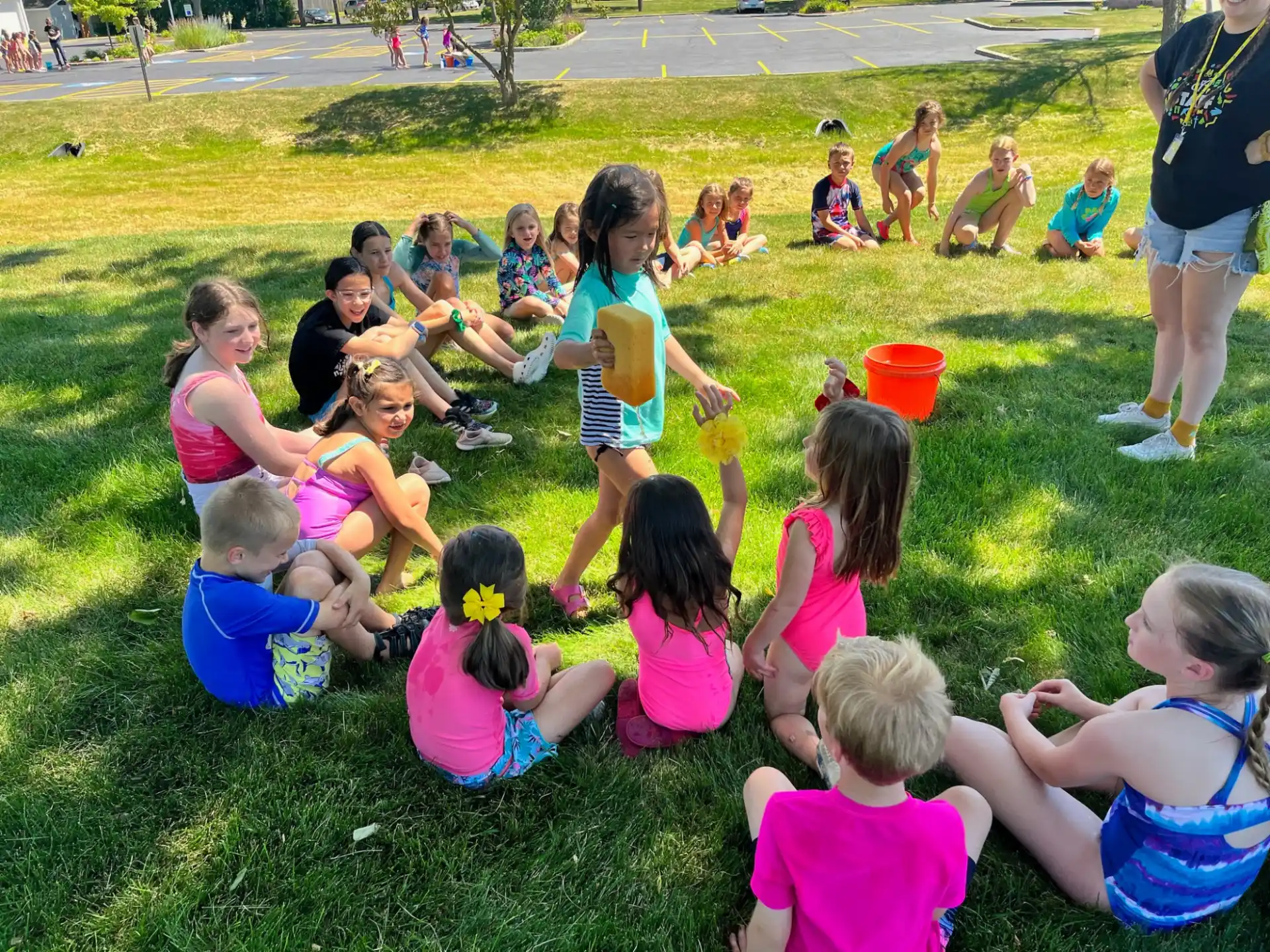 a group of children sitting on the grass