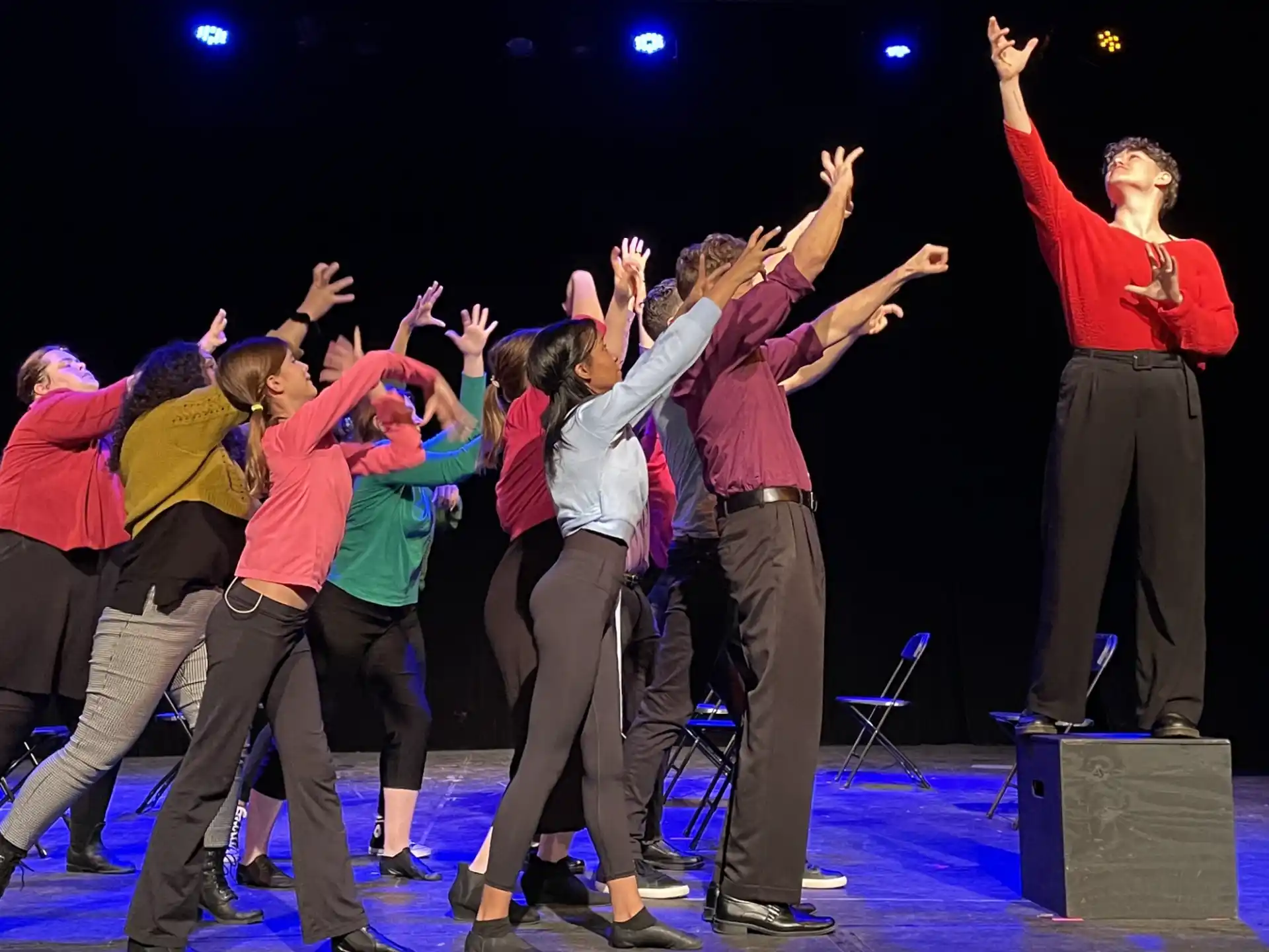 a group of people dancing on a stage