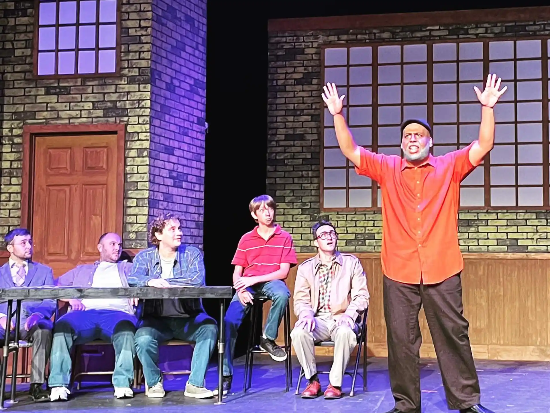 a person standing in front of a group of people sitting in chairs