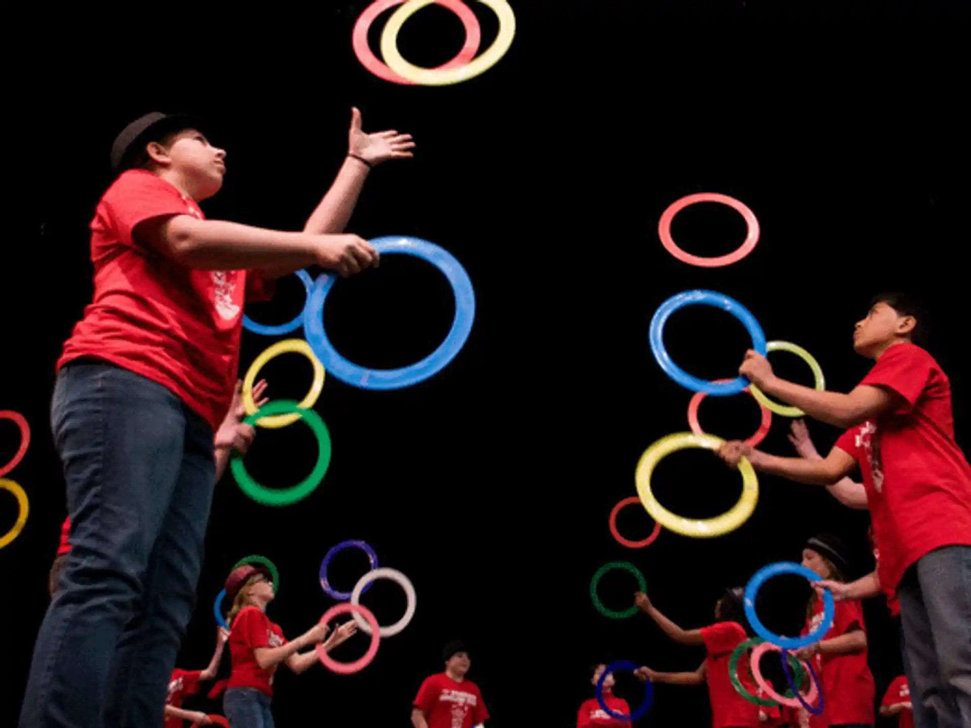 a group of people holding blue rings
