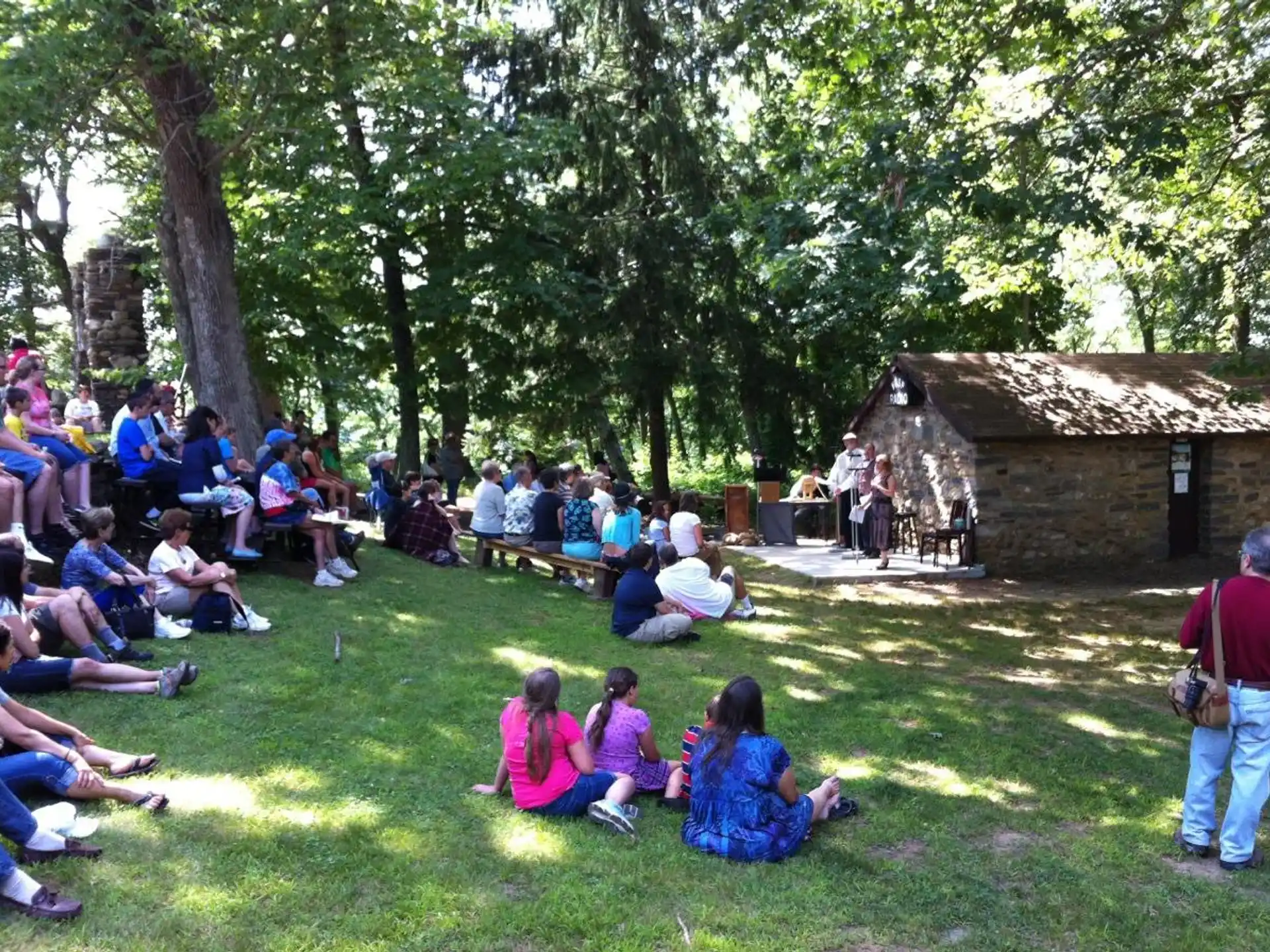 a group of people sitting on the grass