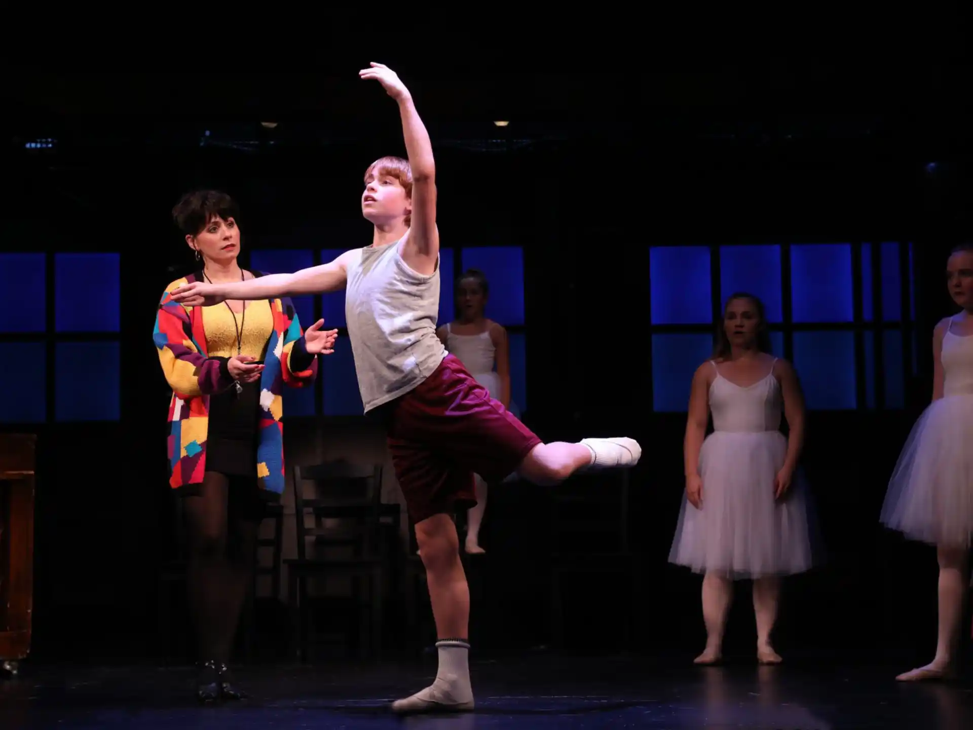 a group of people dancing on a stage