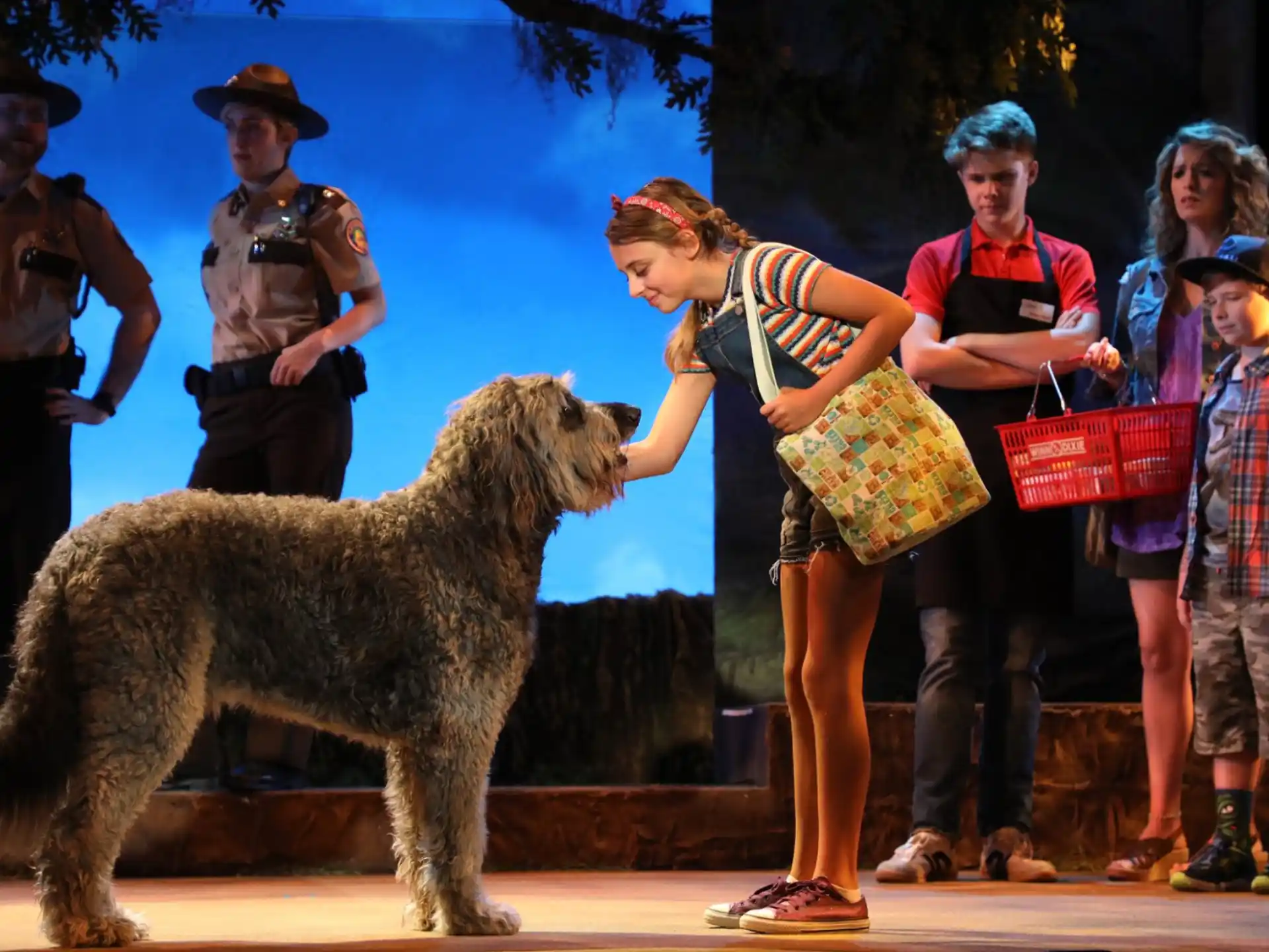 a group of people standing next to a bear