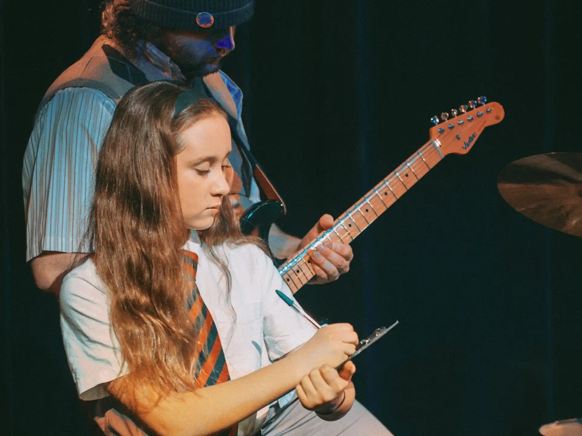 a couple of girls playing guitars