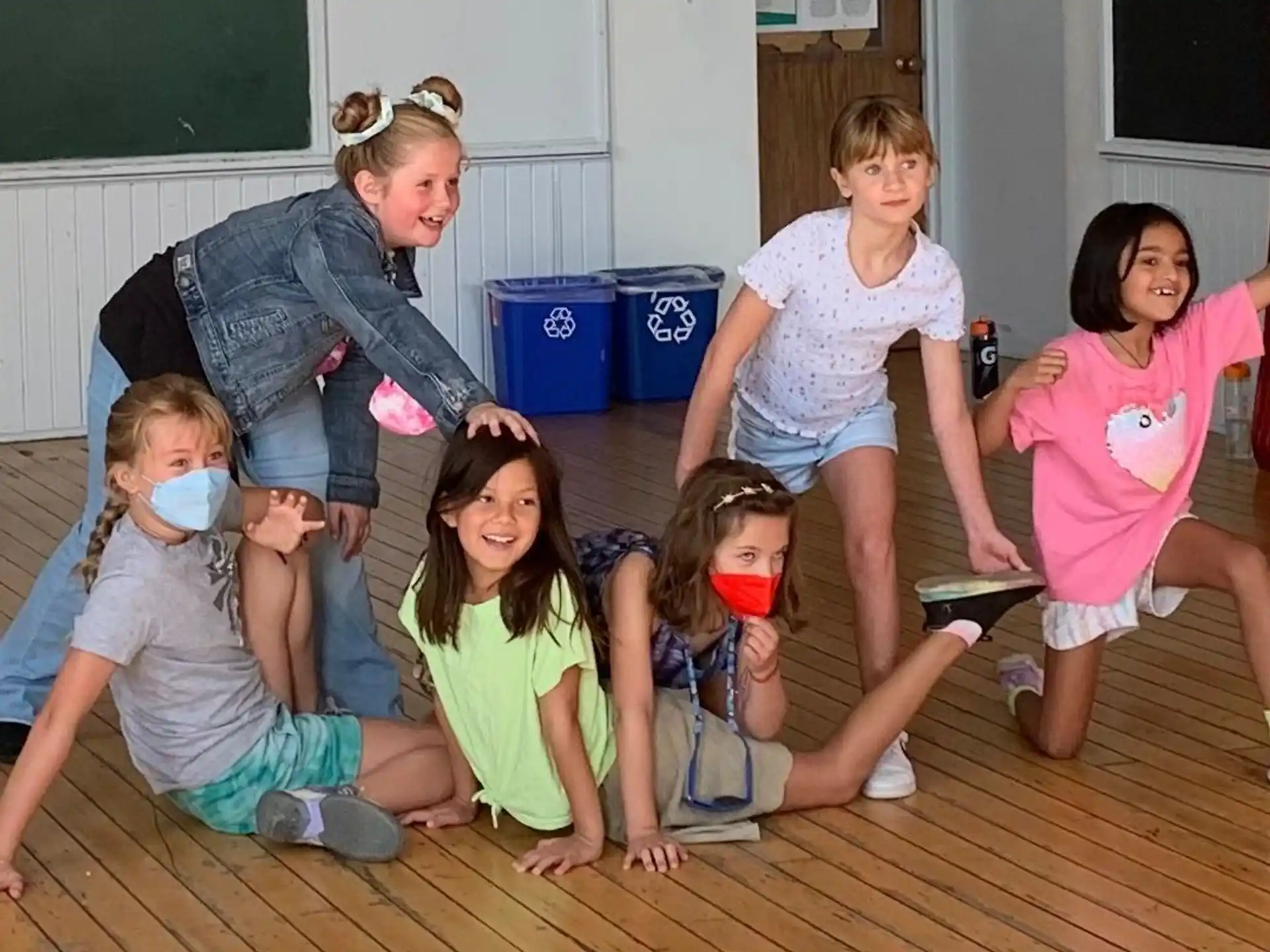 a group of children kneeling on the floor