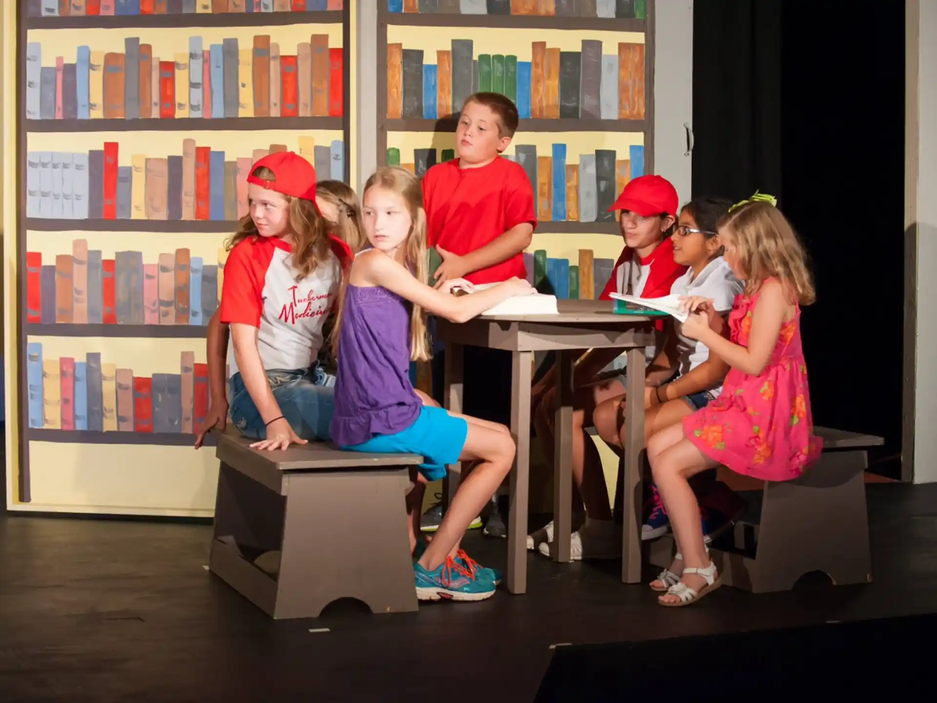 a group of kids sitting at a table