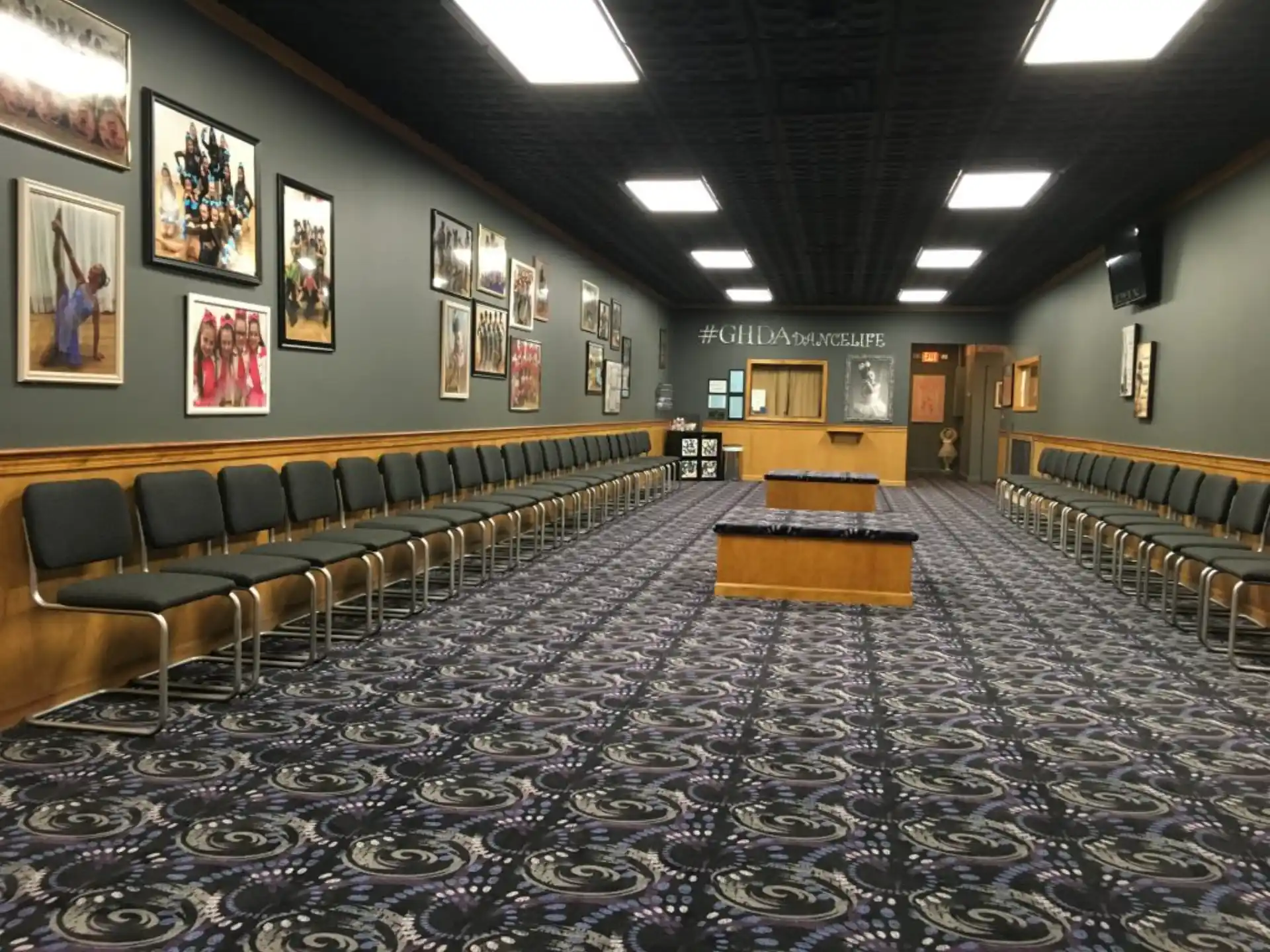 a large room with a carpet and benches