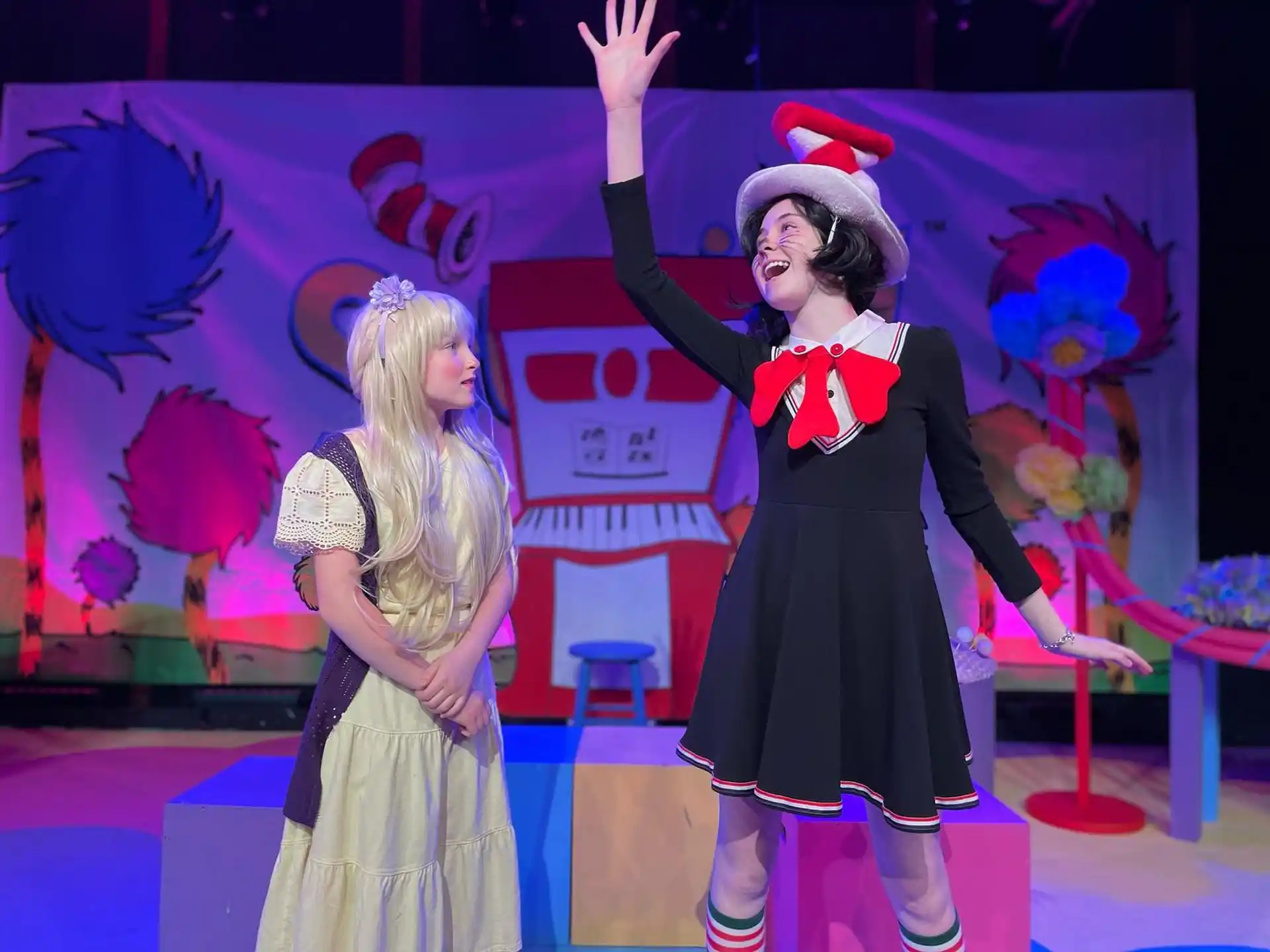 a person and a girl on a stage