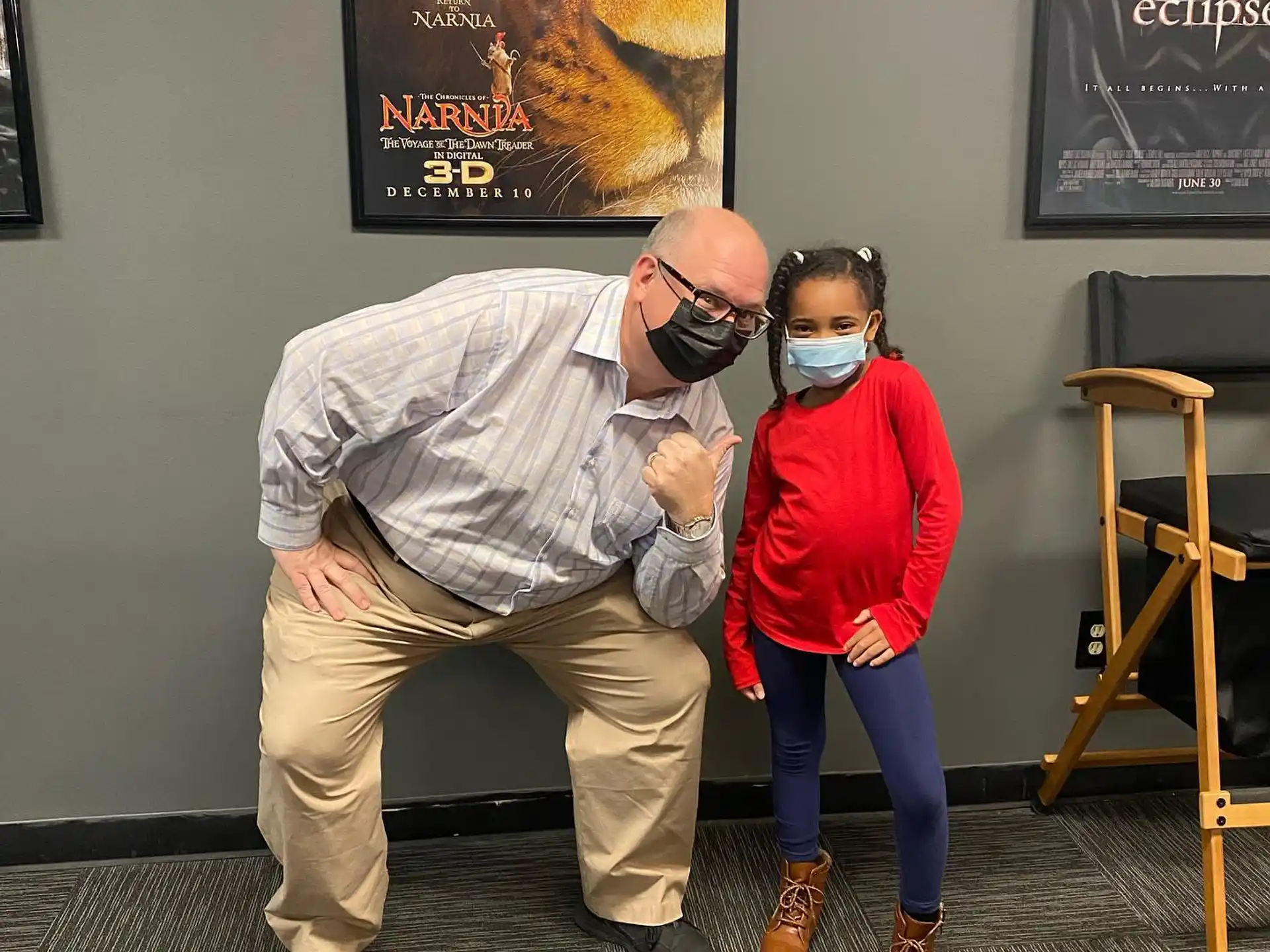 a man and a girl wearing masks