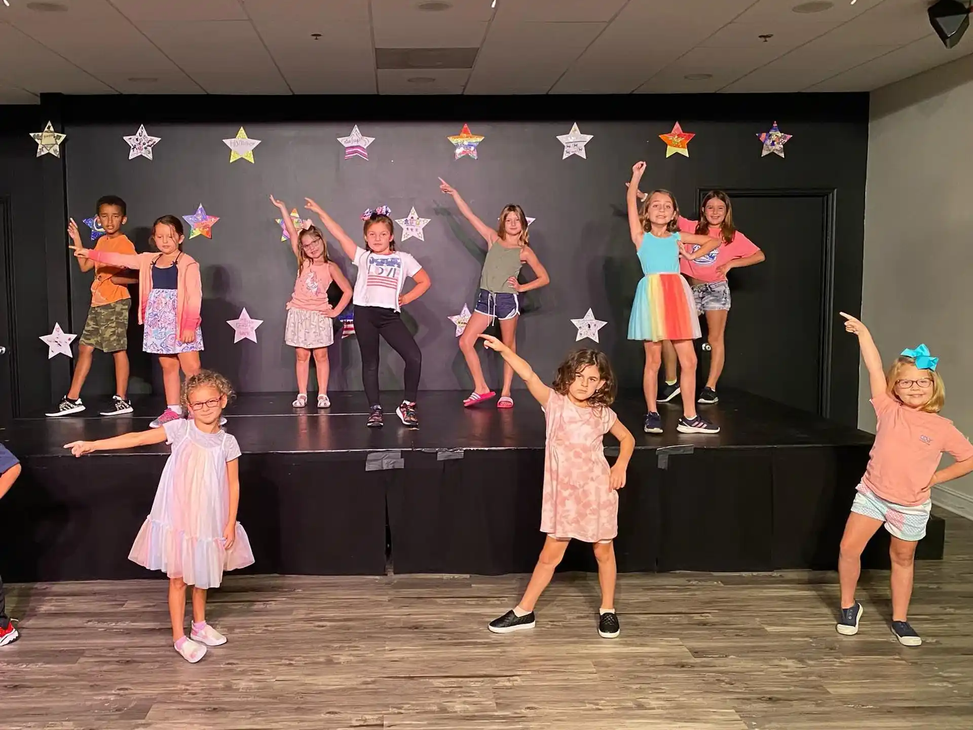 a group of children dancing on a stage