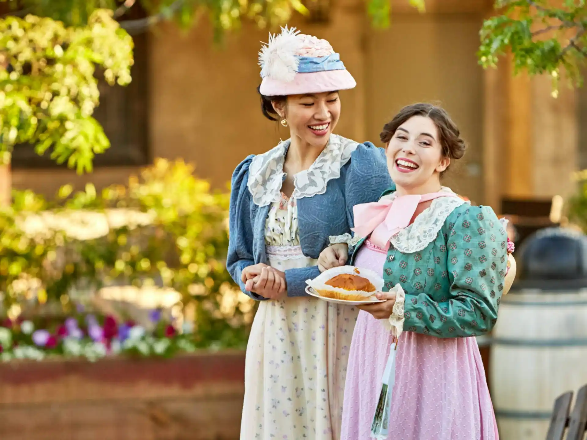 a couple of women holding a plate of food
