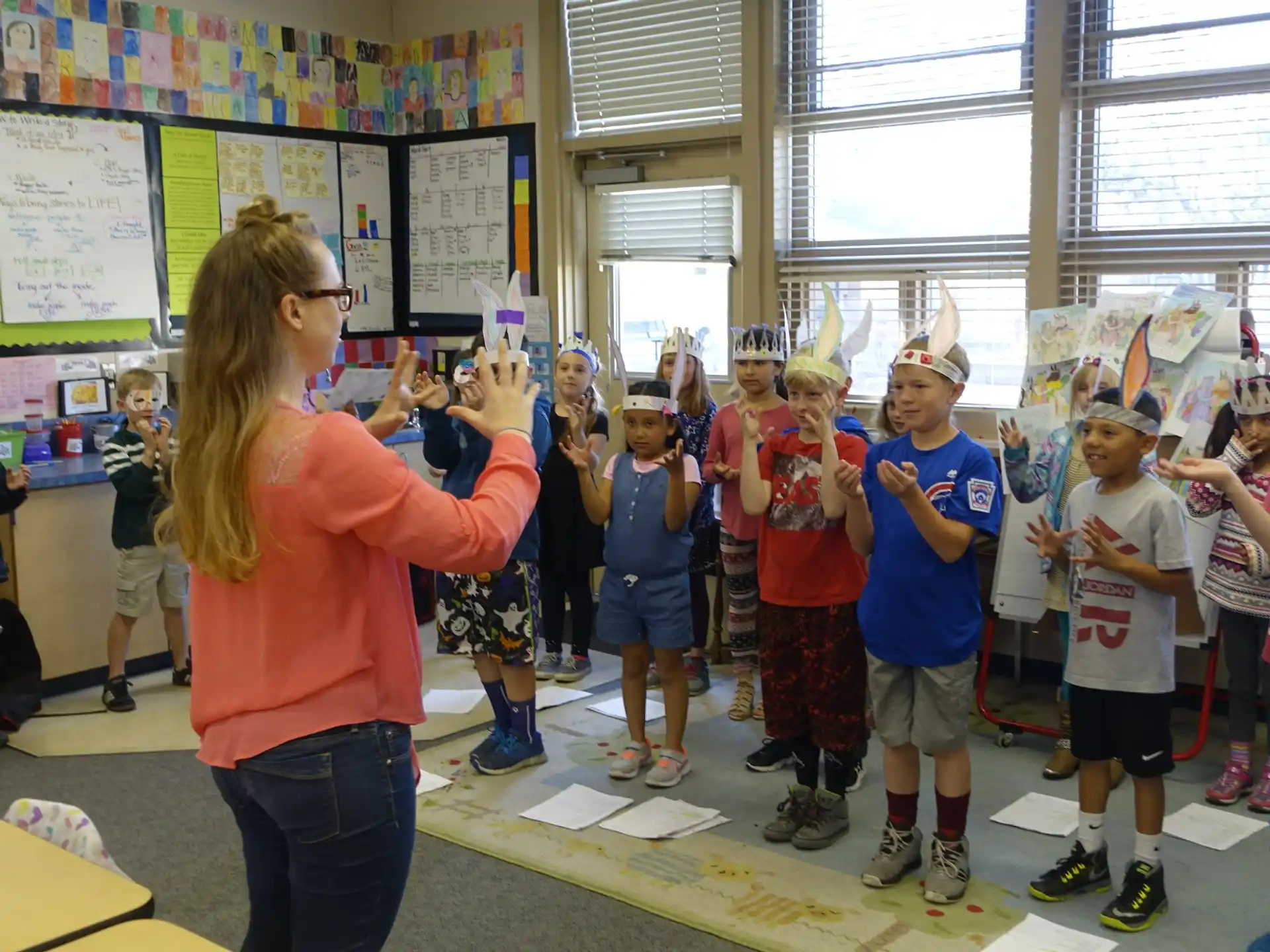 a woman teaching children in a classroom