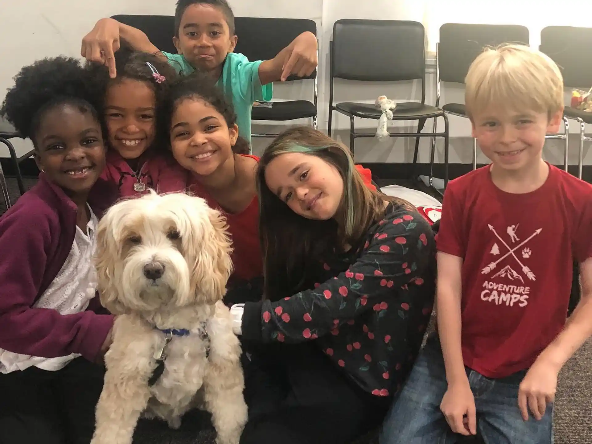 a group of people posing for a photo with a dog