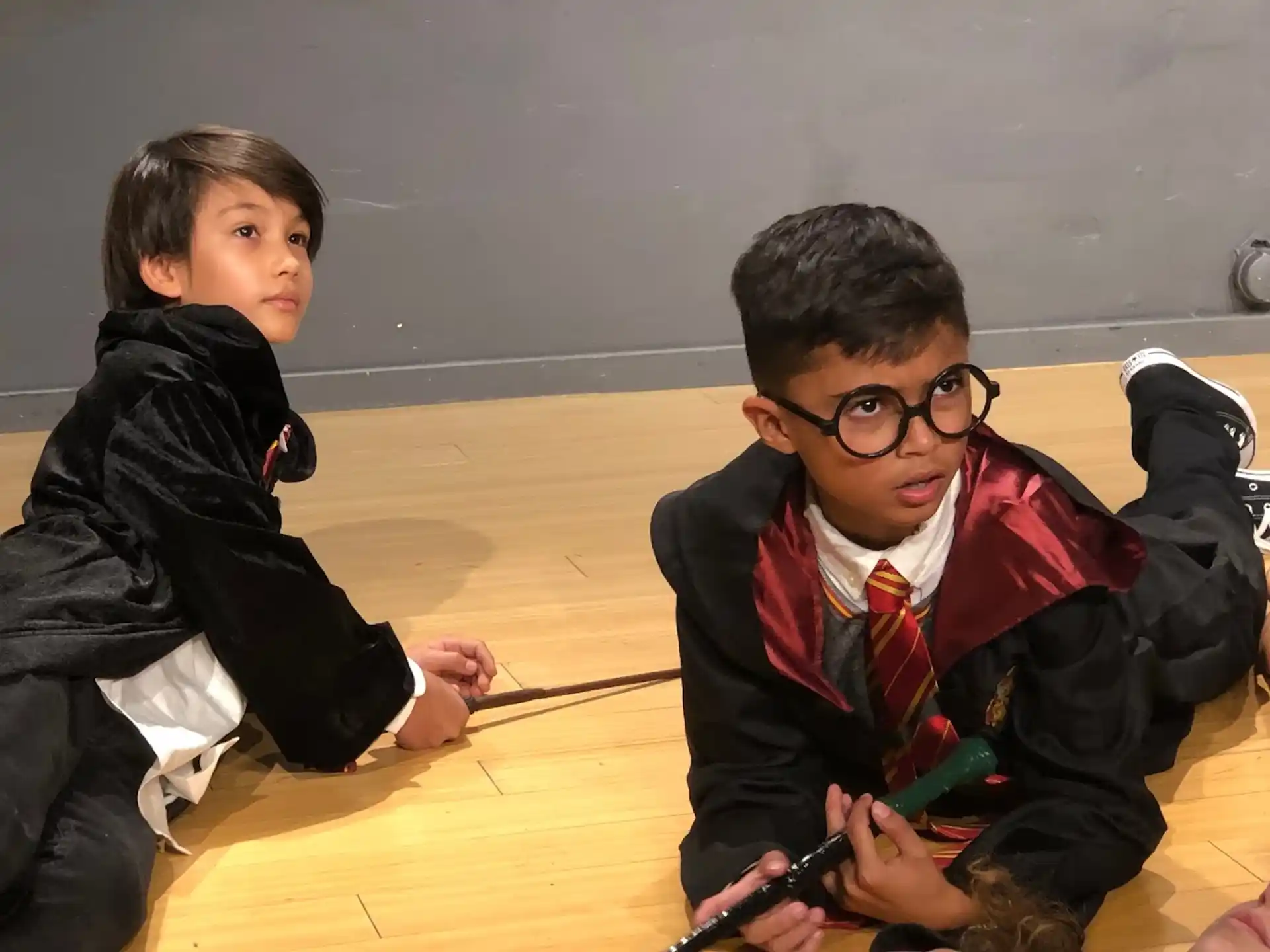 a couple of boys sitting on the floor