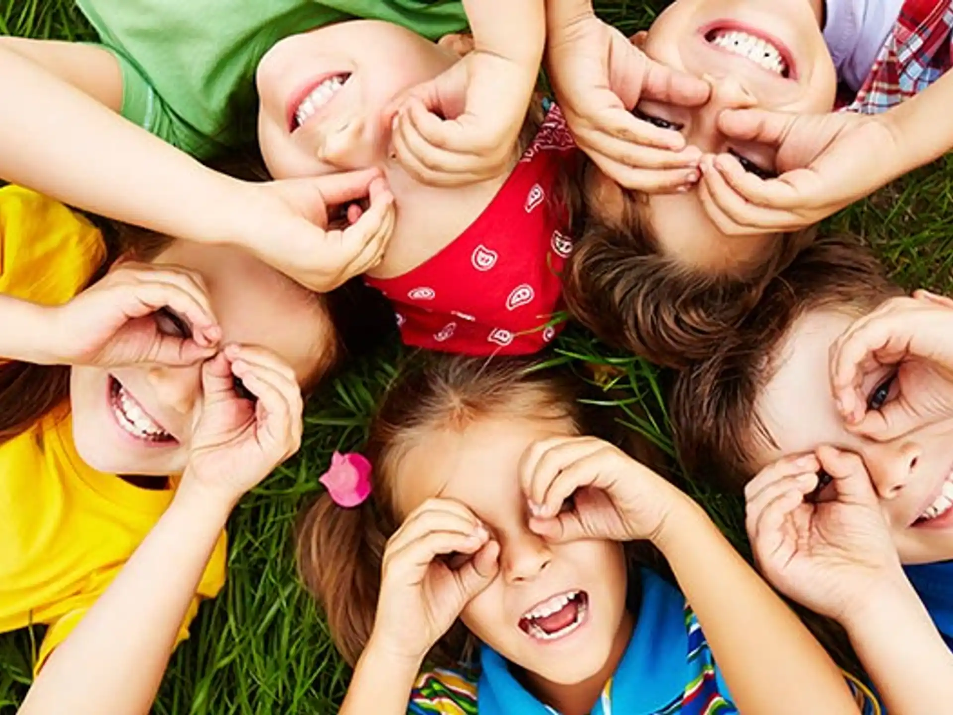 a group of children lying on the ground smiling