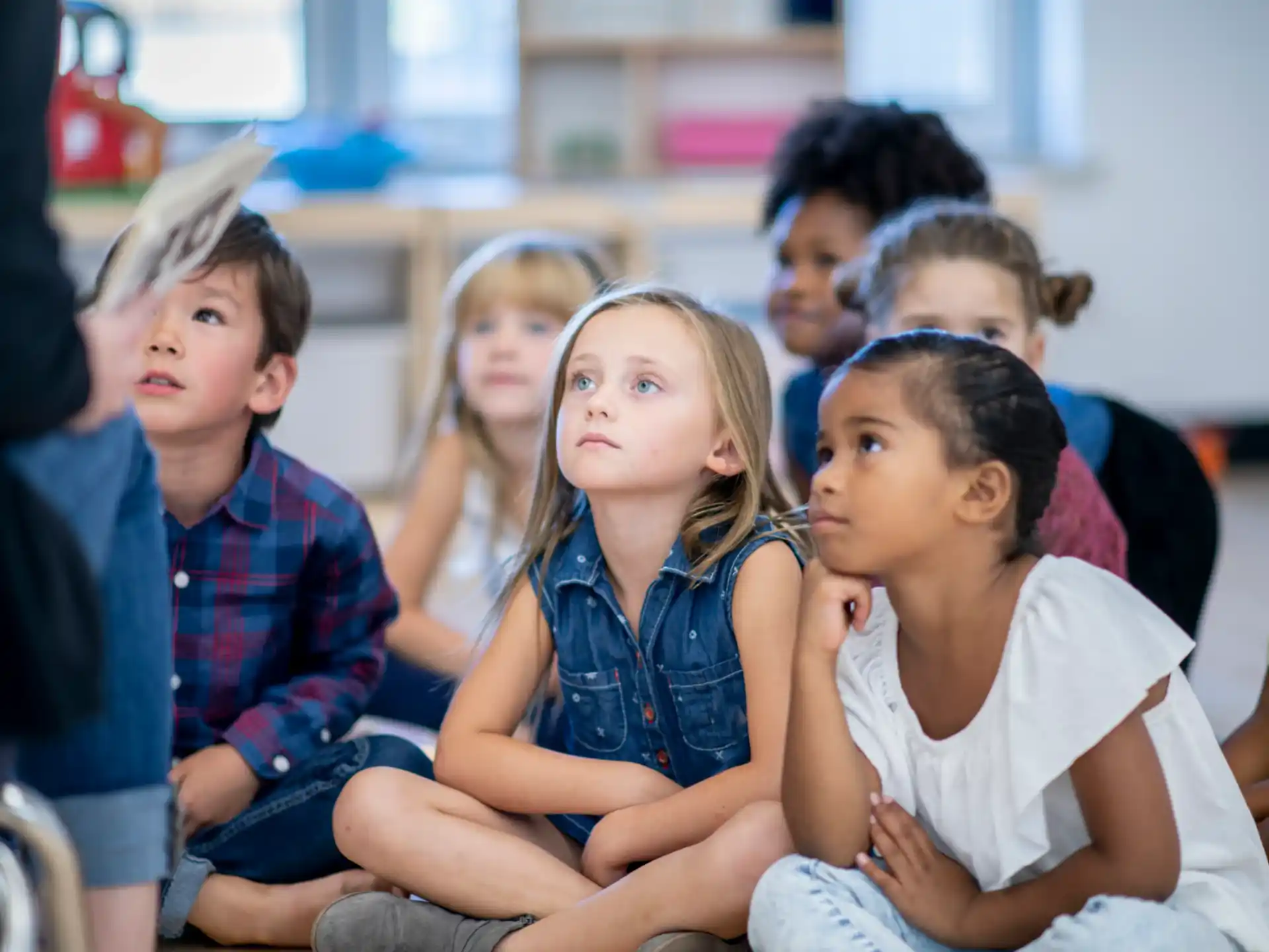 a group of children sitting in chairs
