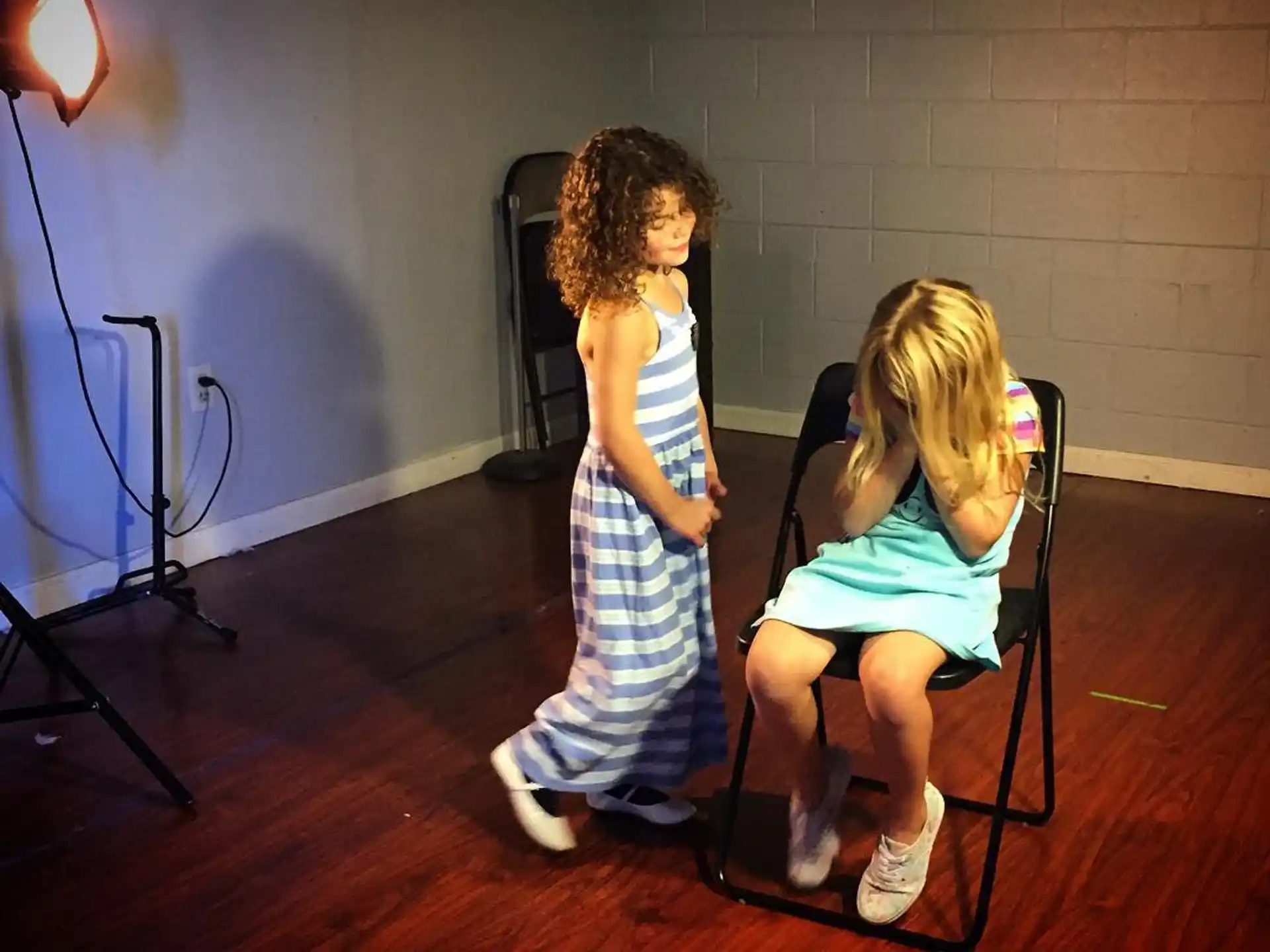 a couple of girls sitting in chairs