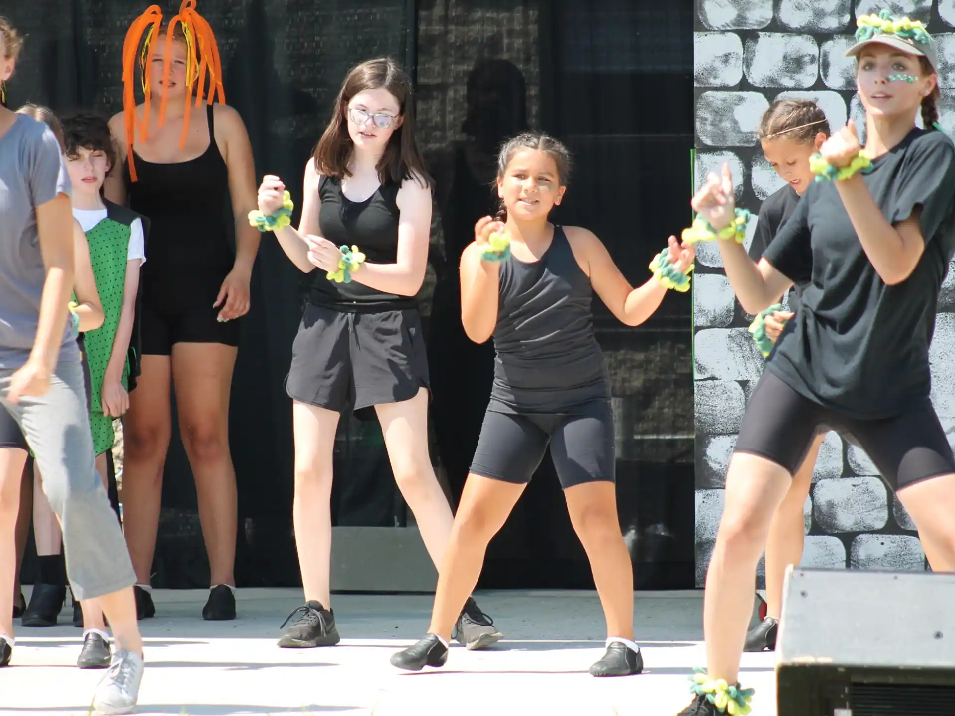 a group of people wearing black shirts and holding flowers