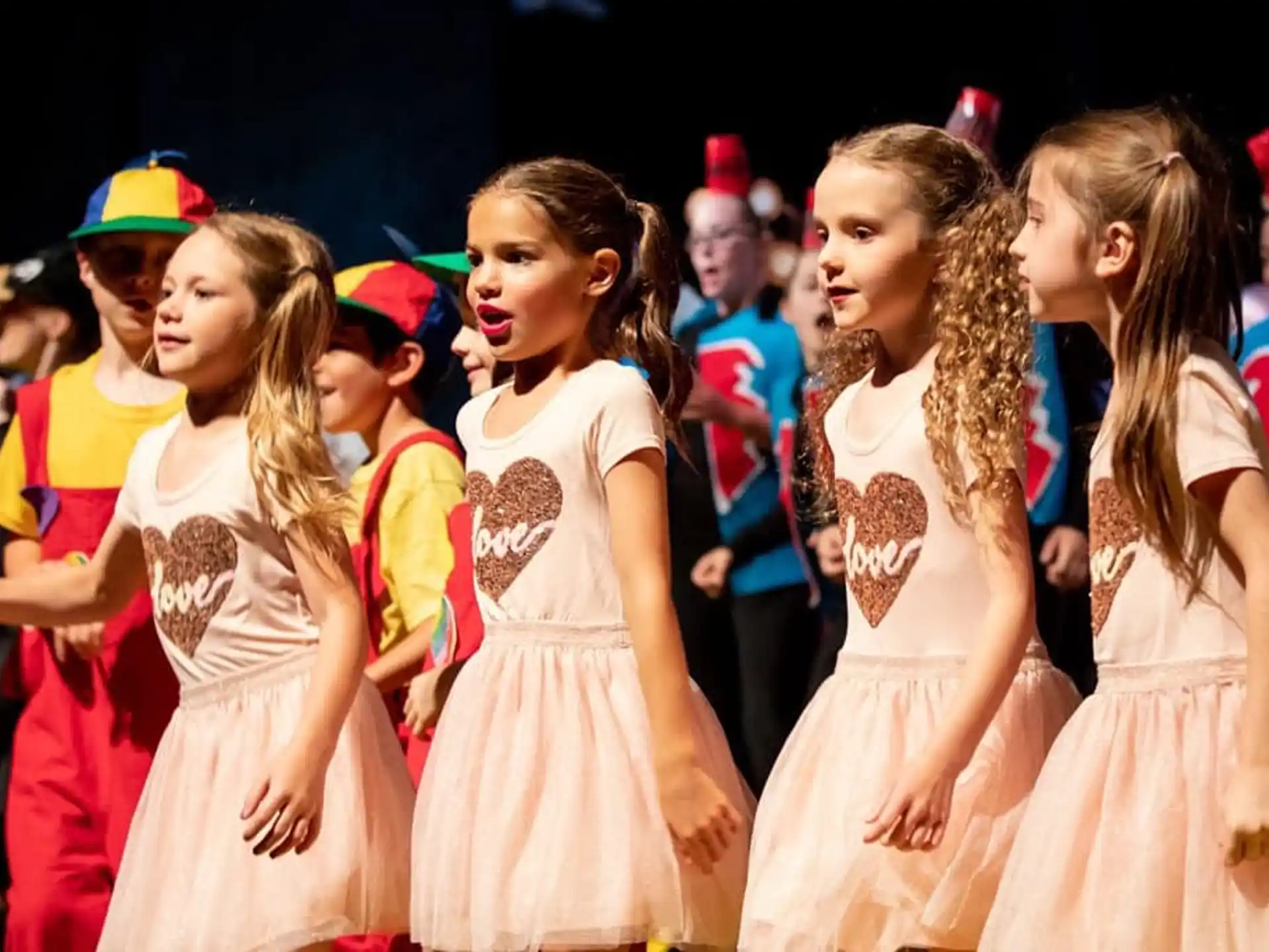 a group of girls in dresses