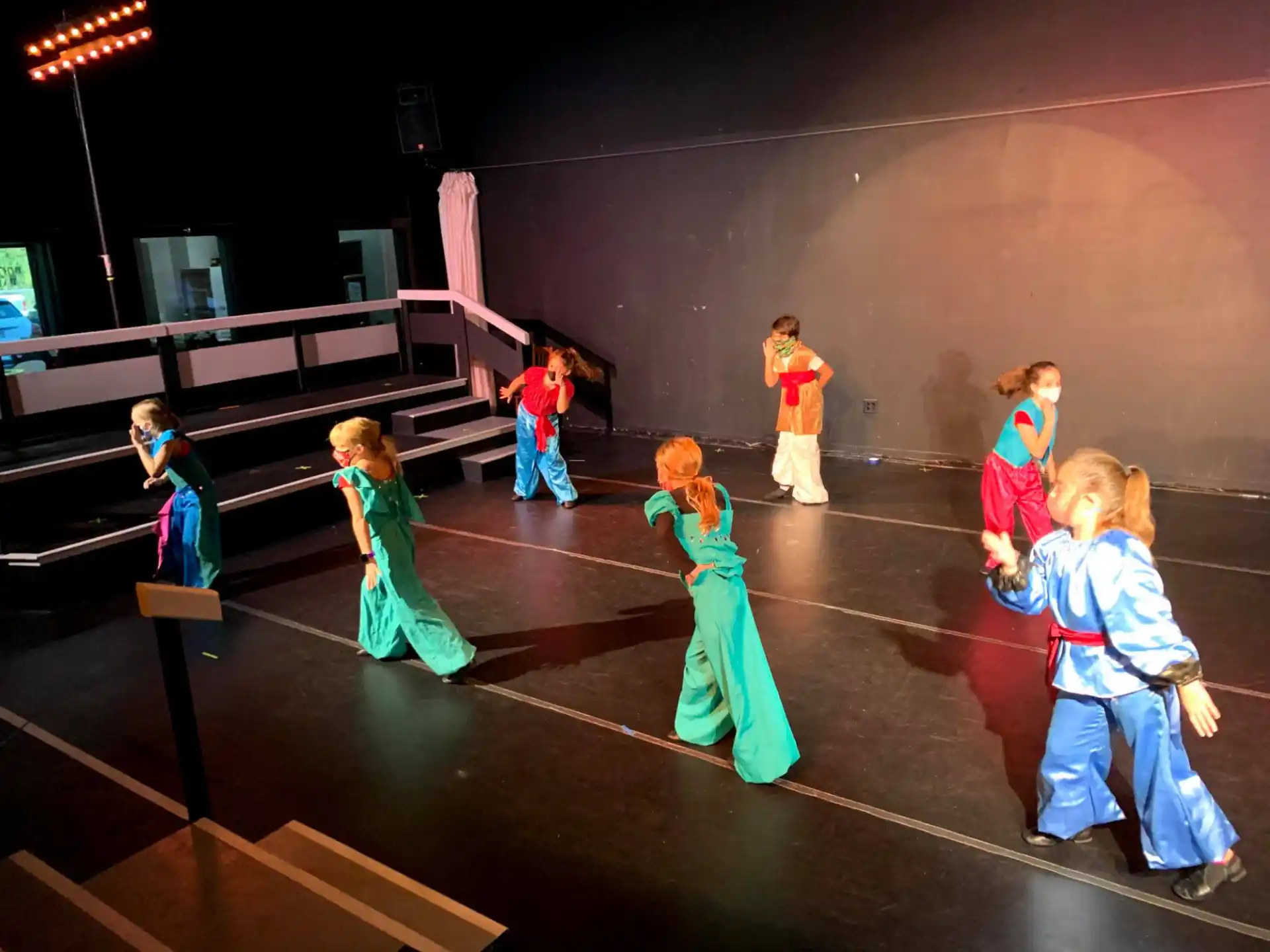 a group of children dancing on a stage