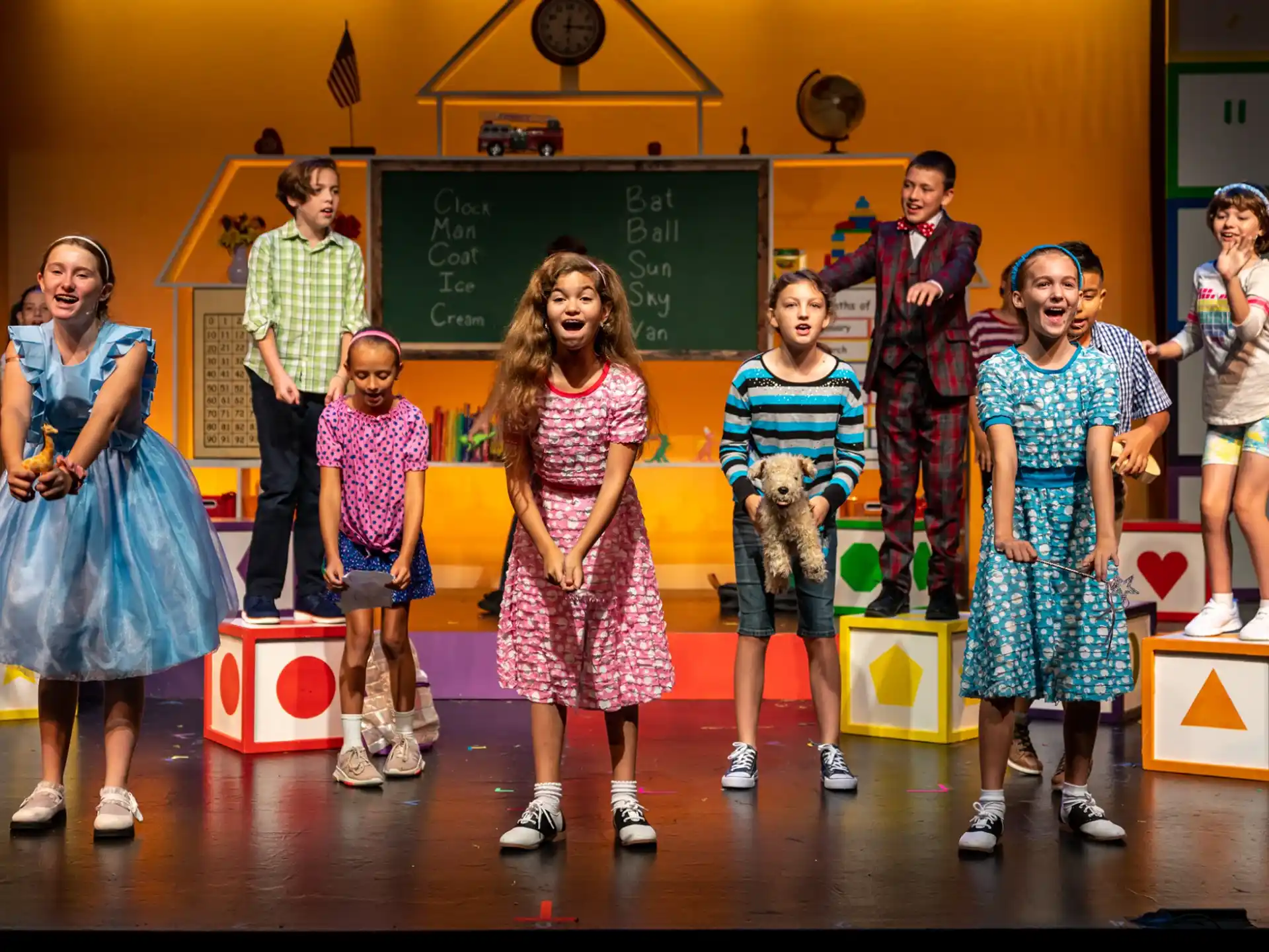 a group of children standing on a stage