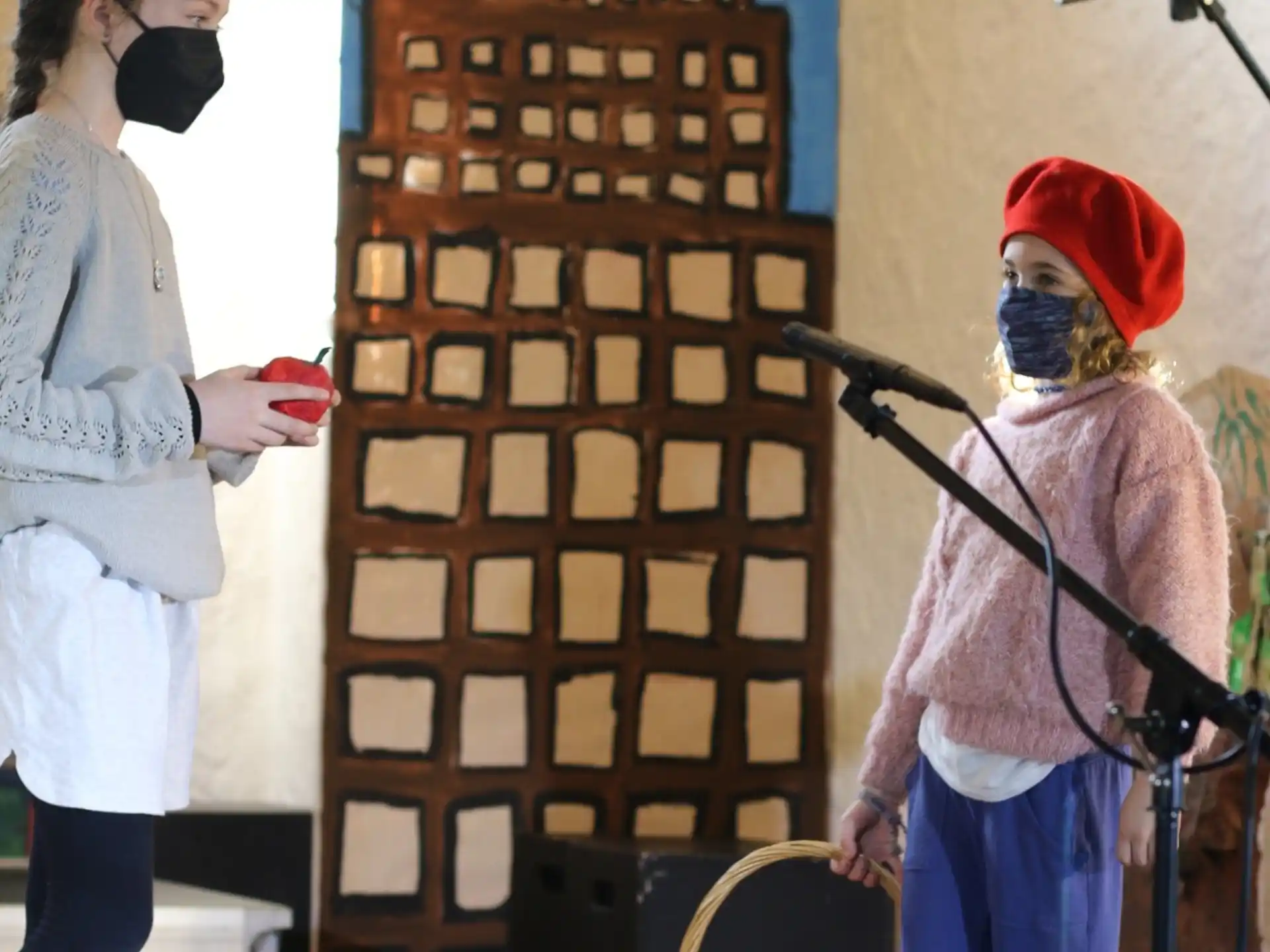 a person wearing a mask and a mask standing next to a person wearing a mask