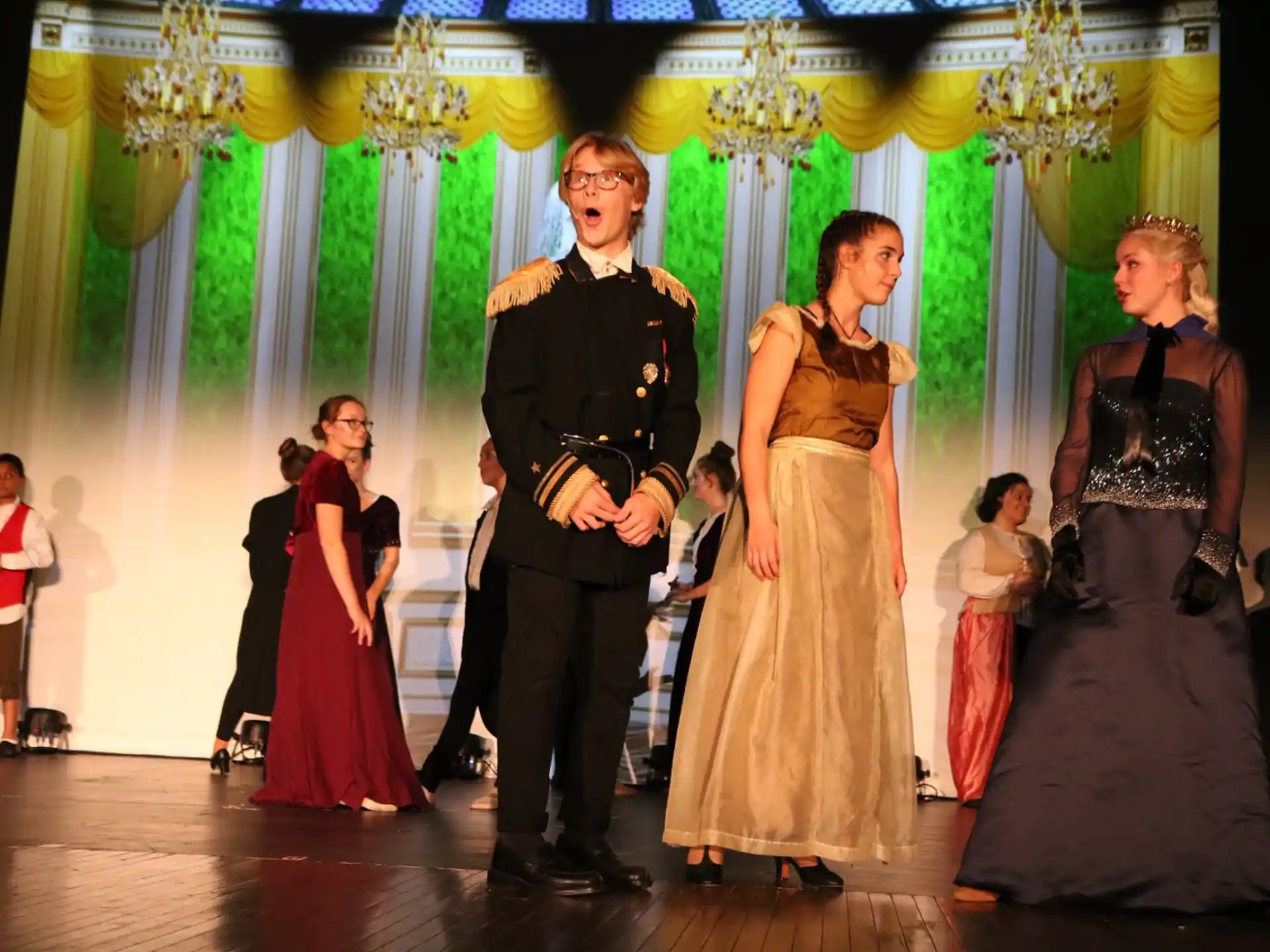 a man and a woman dancing on a stage with other people