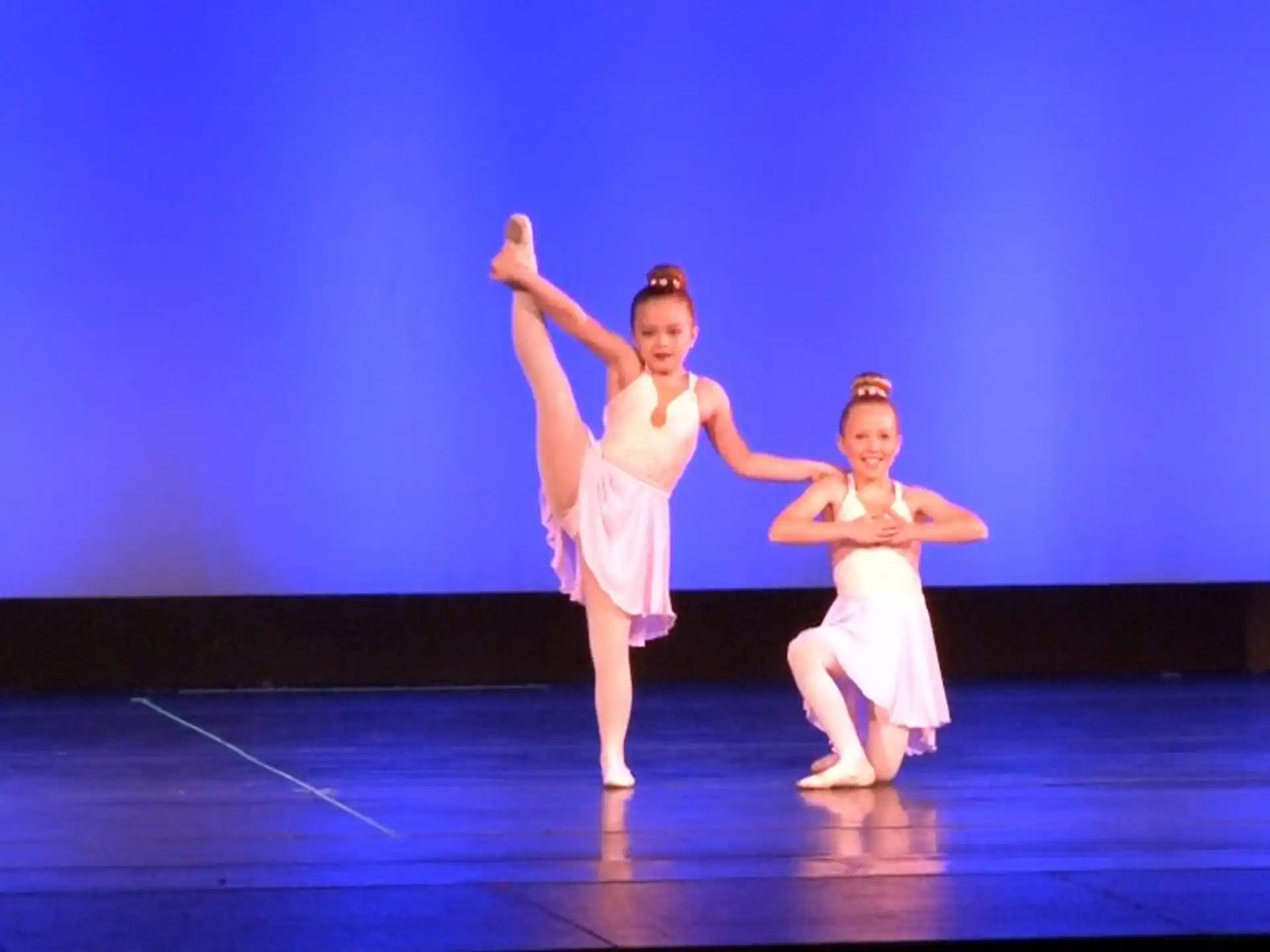 two women dancing on a stage