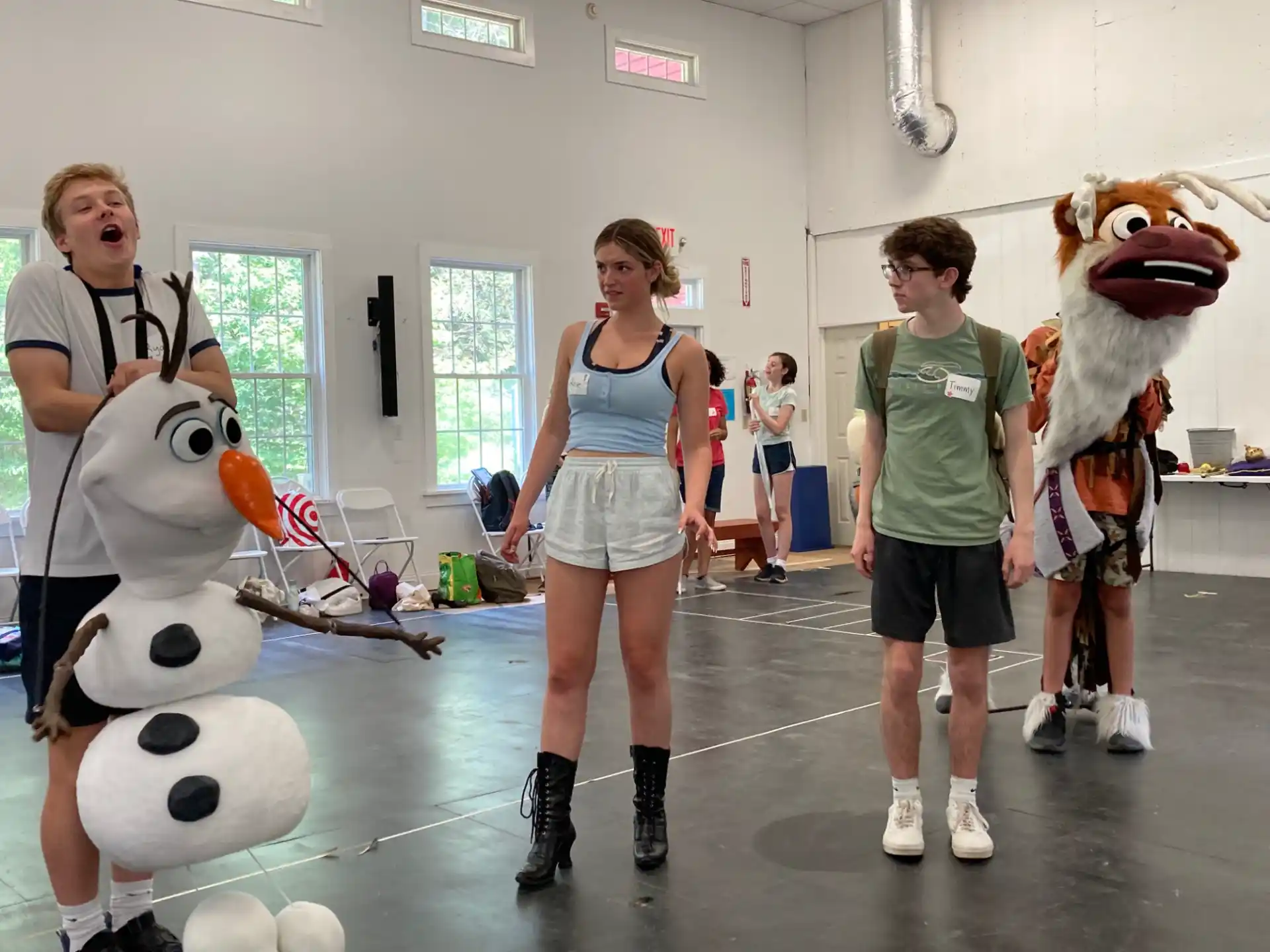 a group of people in a room with mascots