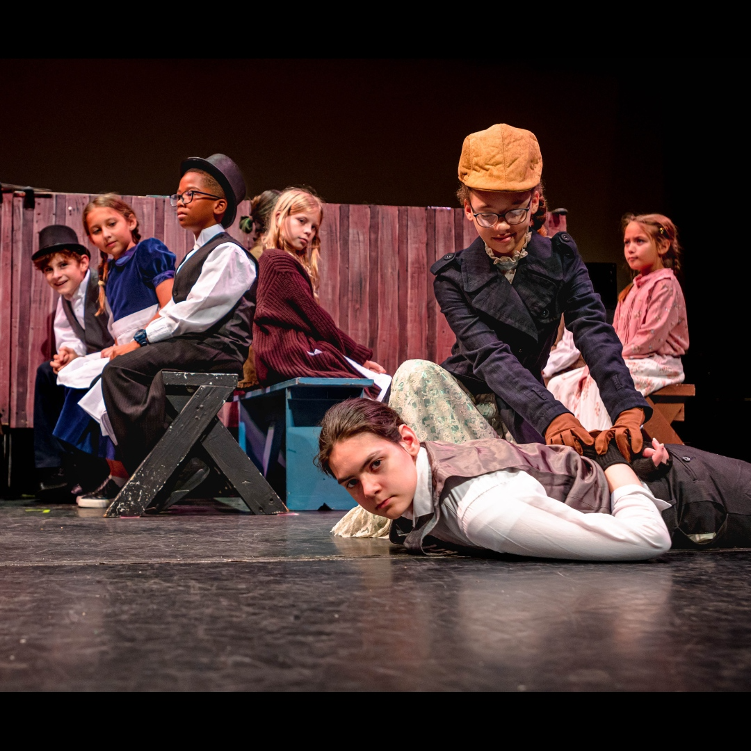 a group of people sitting on a stage