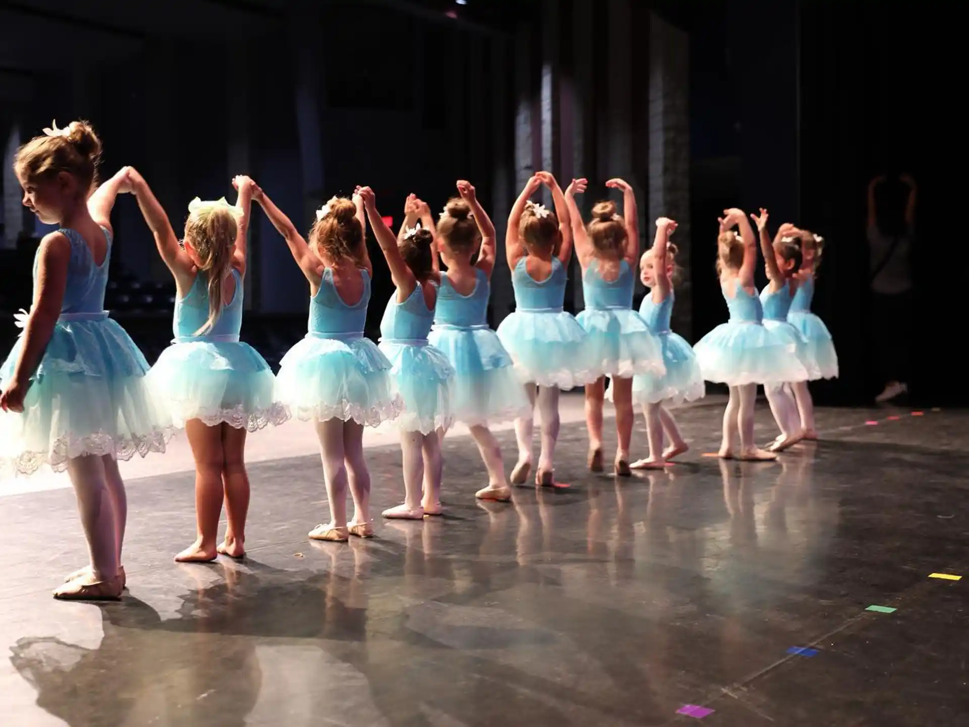 a group of girls in blue dresses