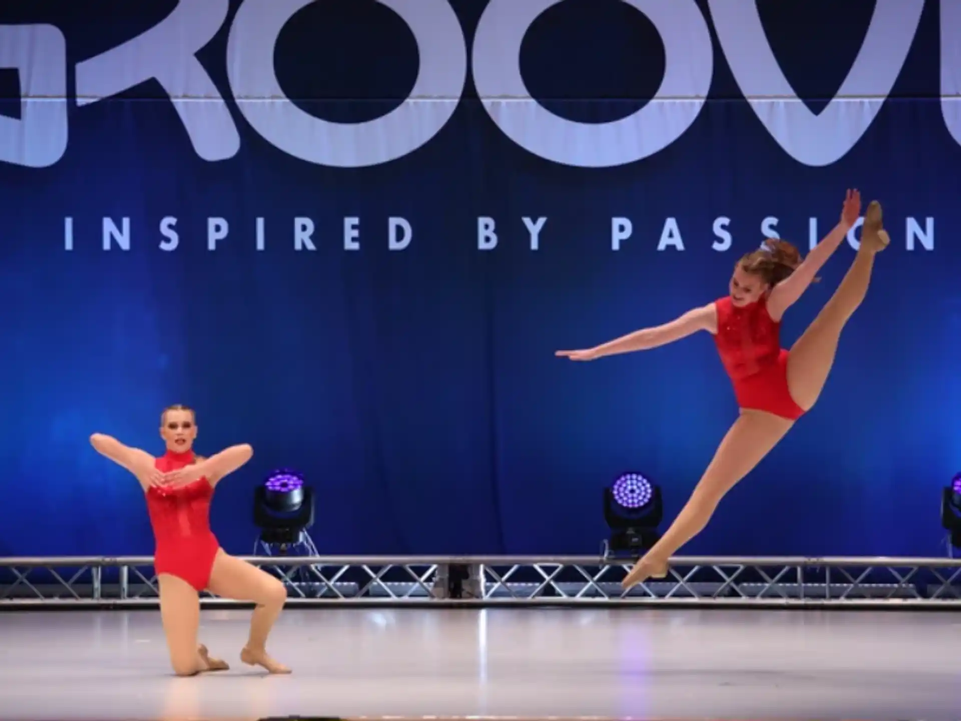 a couple of women dancing on a stage