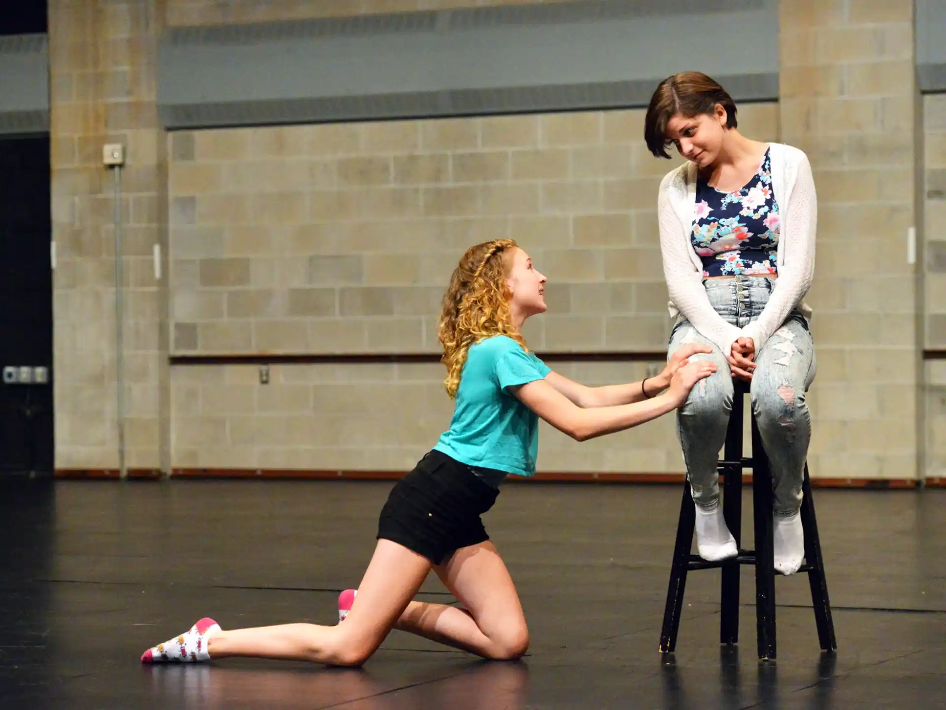 a person and a girl sitting on a chair