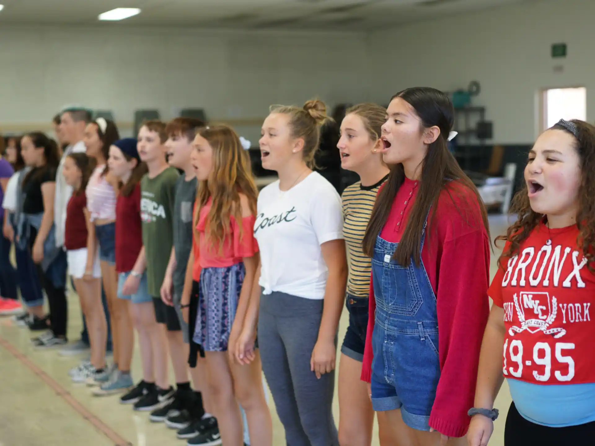 a group of girls standing in a room