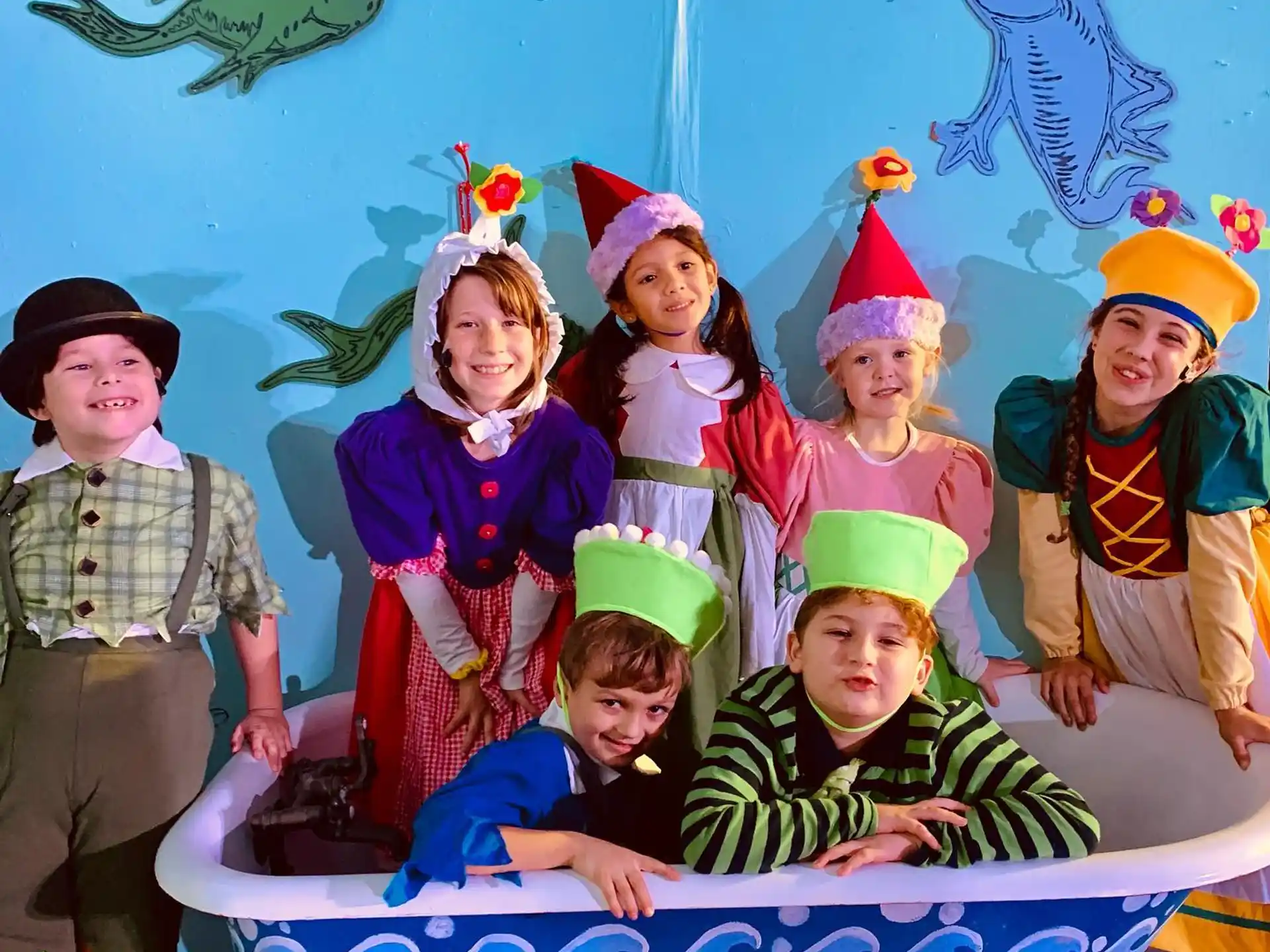 a group of children wearing party hats