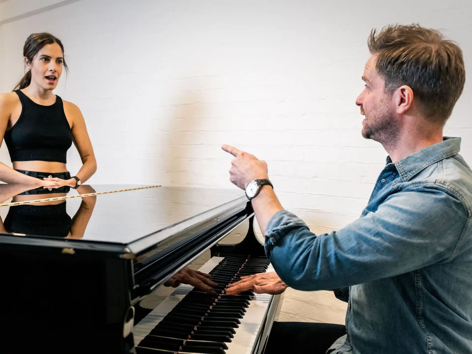 a man and woman playing piano
