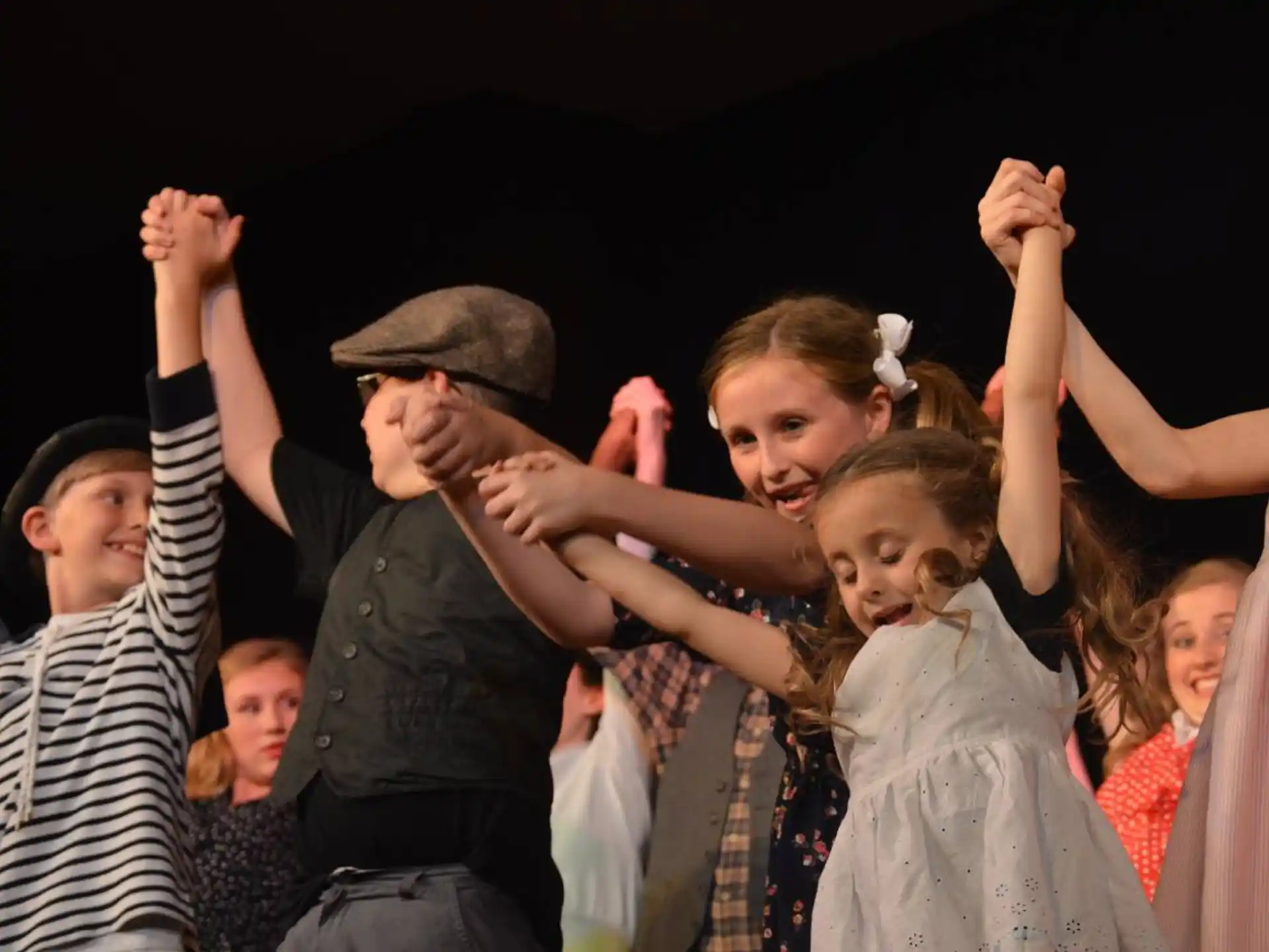 a group of people with their hands up