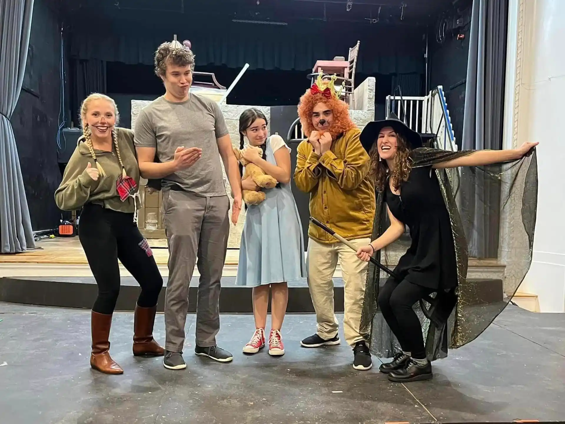 a group of people posing with a person in a garment