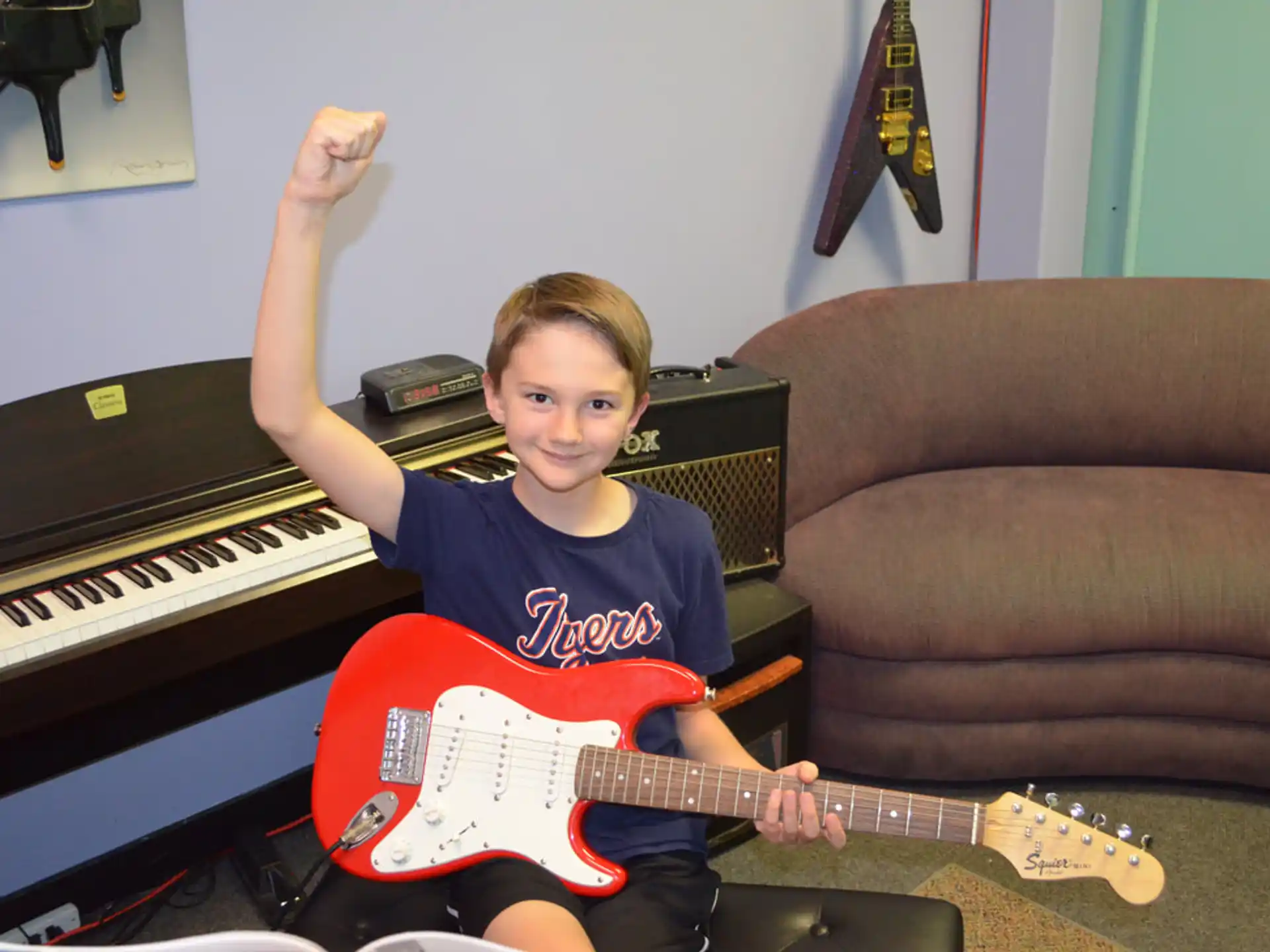 a boy playing a guitar