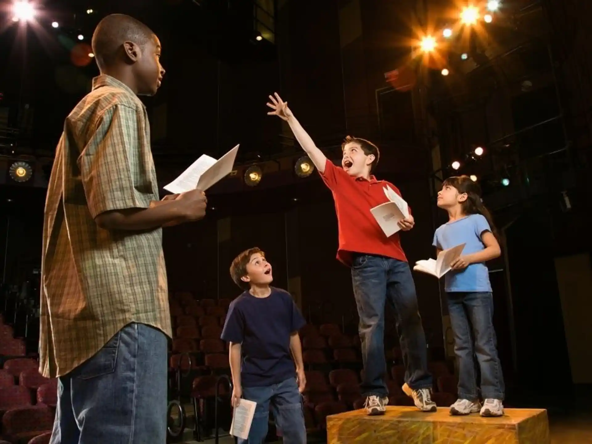 a group of people standing on a stage with papers in front of them