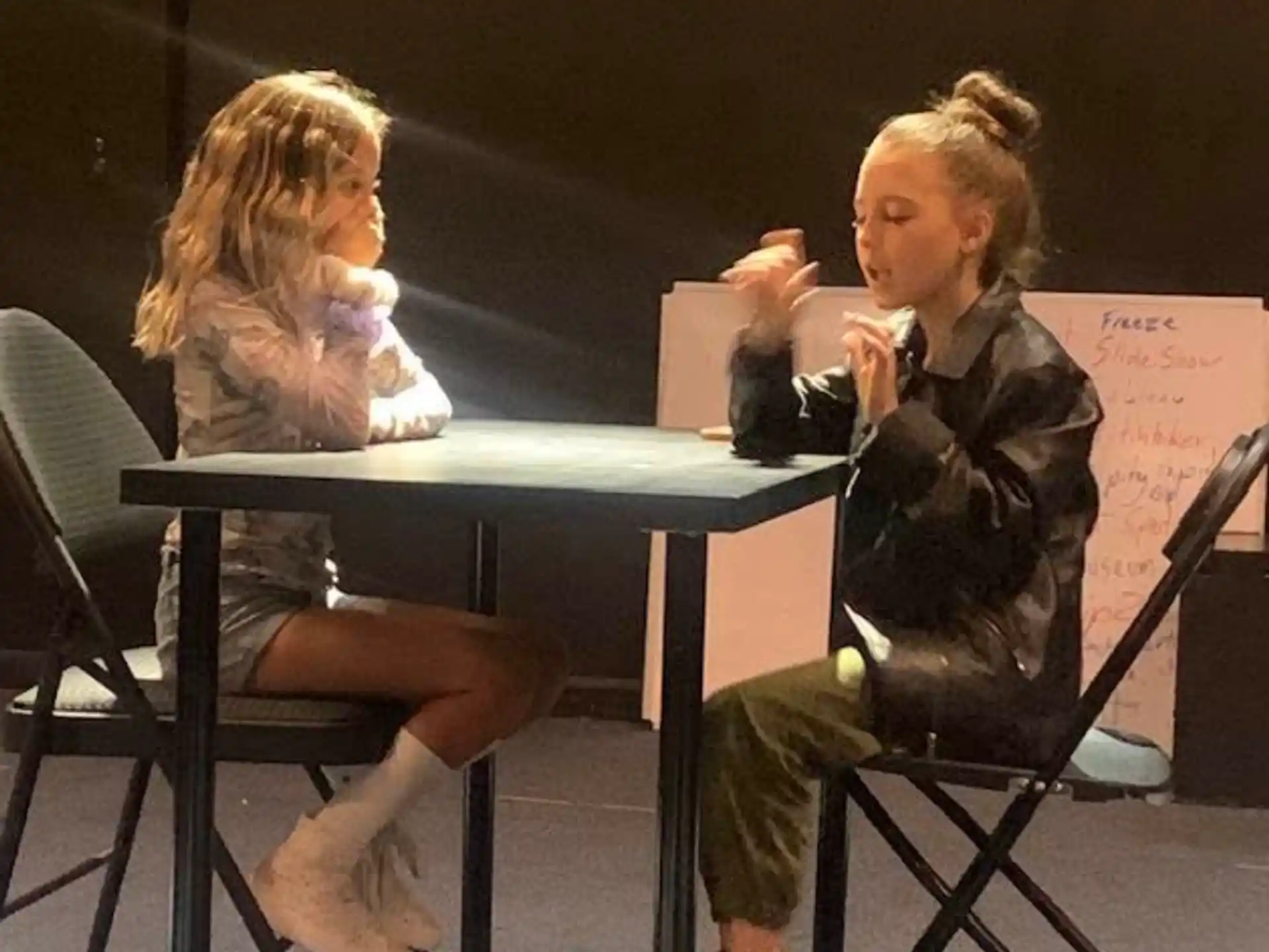 a person and a child sitting at a table