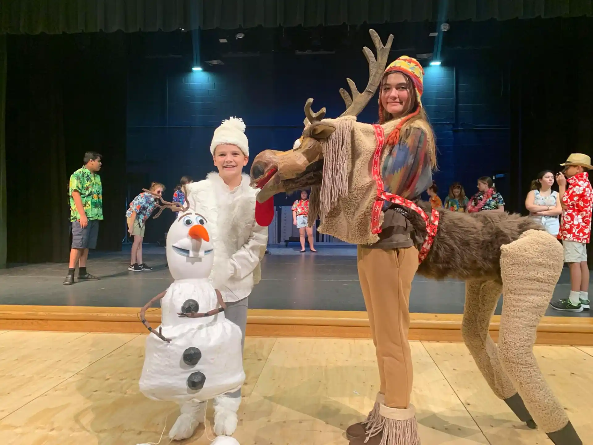a person and a couple of stuffed animals on a stage