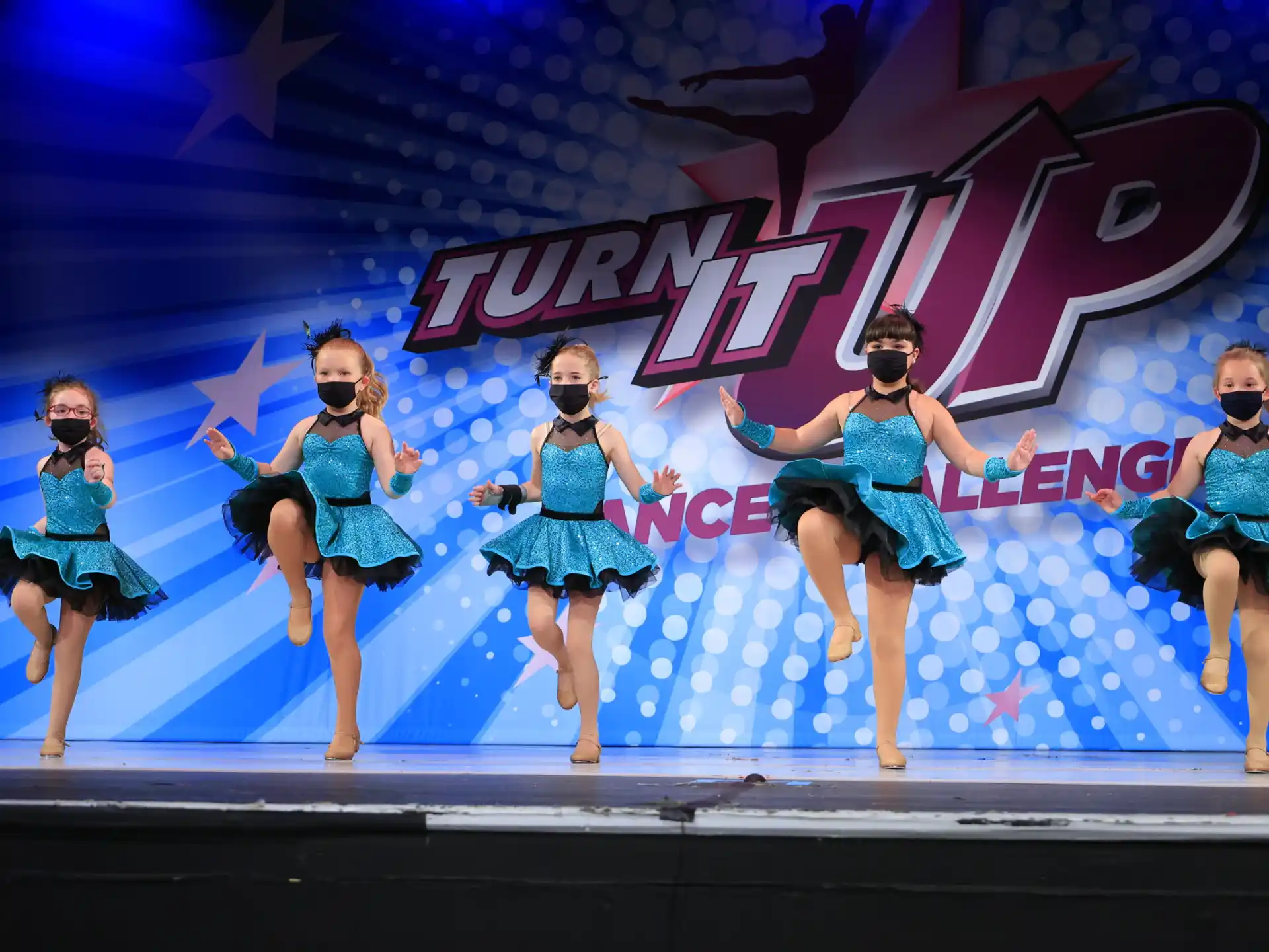 a group of women dancing on a stage