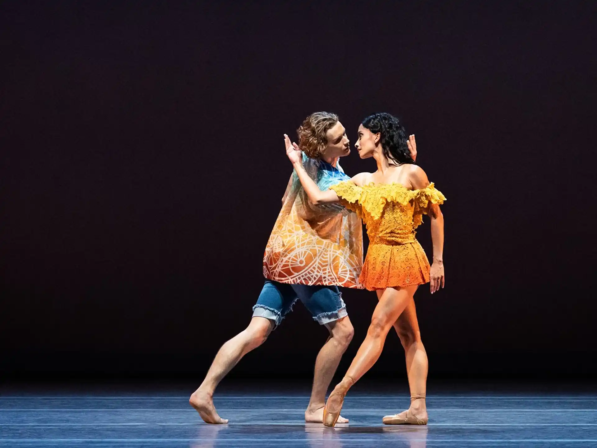 a man and woman dancing on a stage