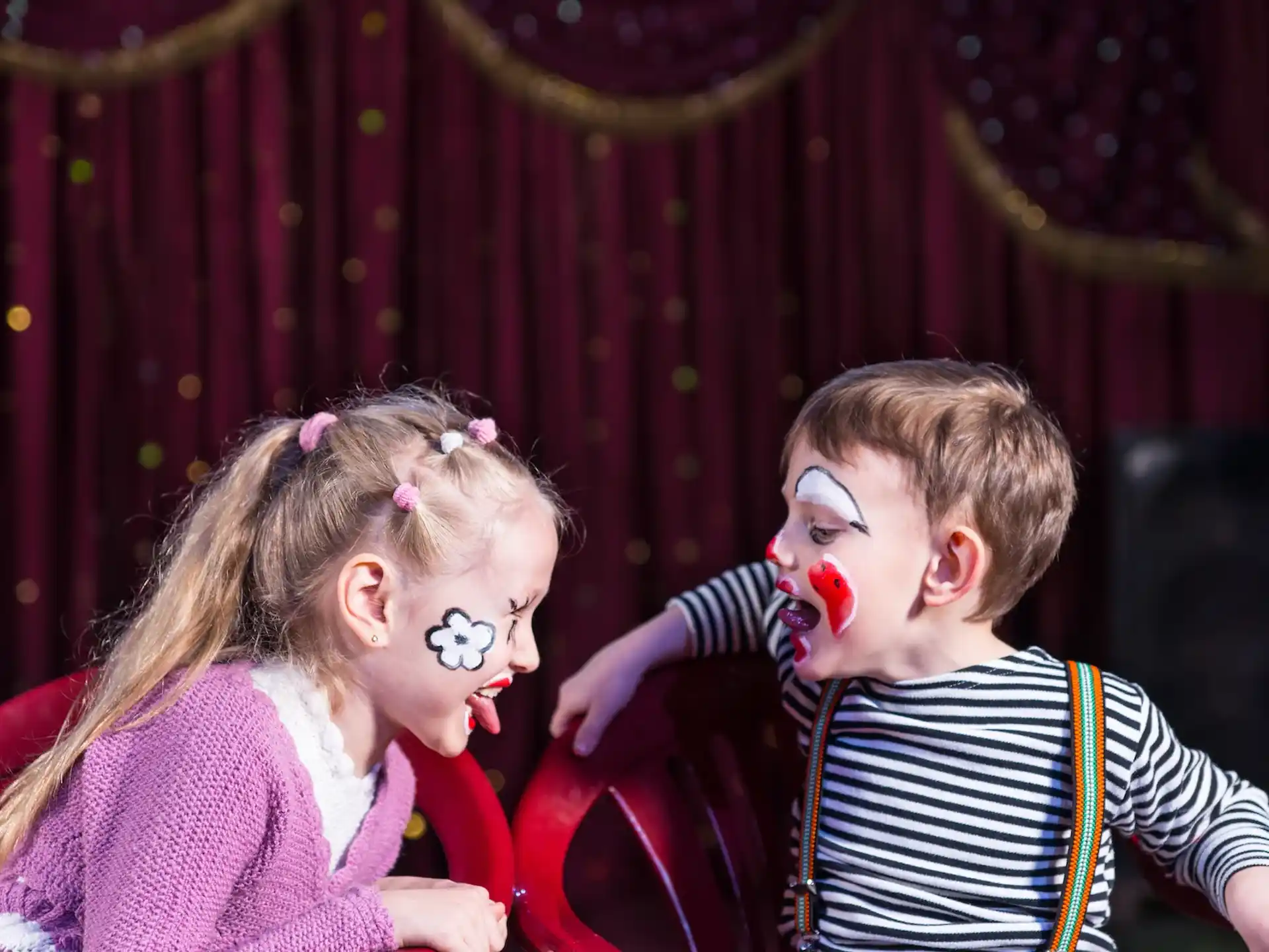 a boy and girl with paint on their faces